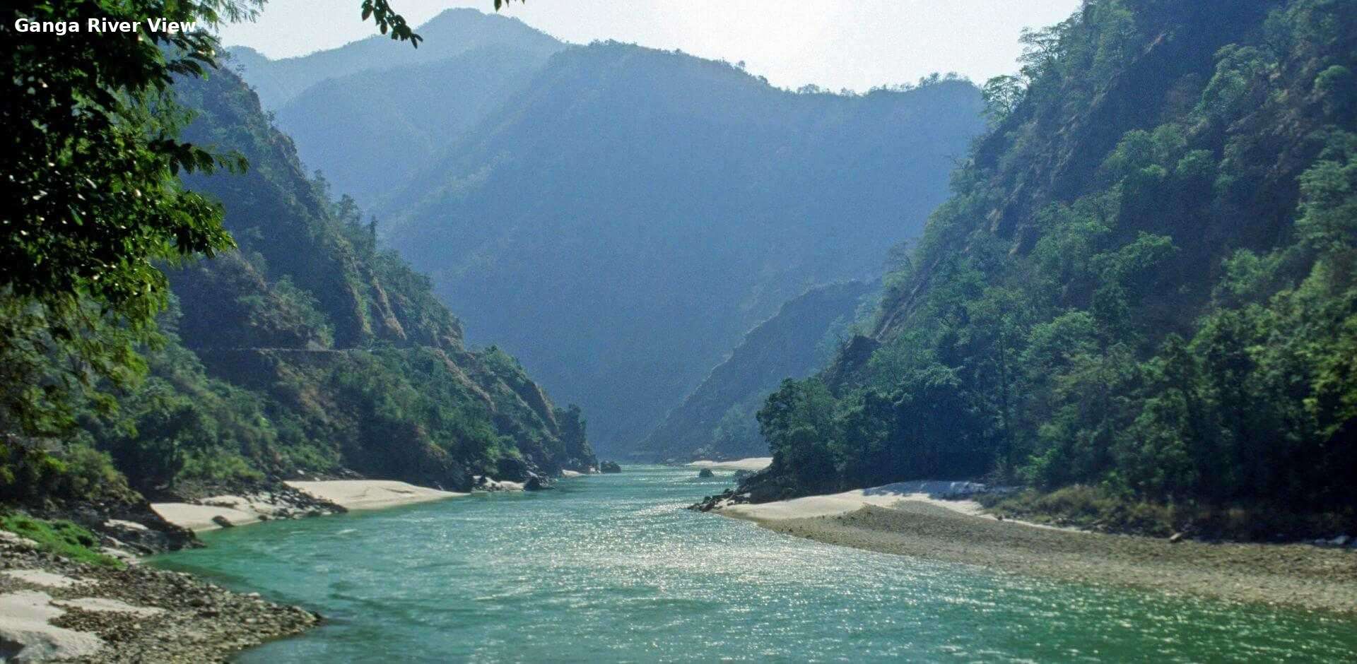 Scenic Ganga river view near Rishikesh surrounded by mountains and greenery