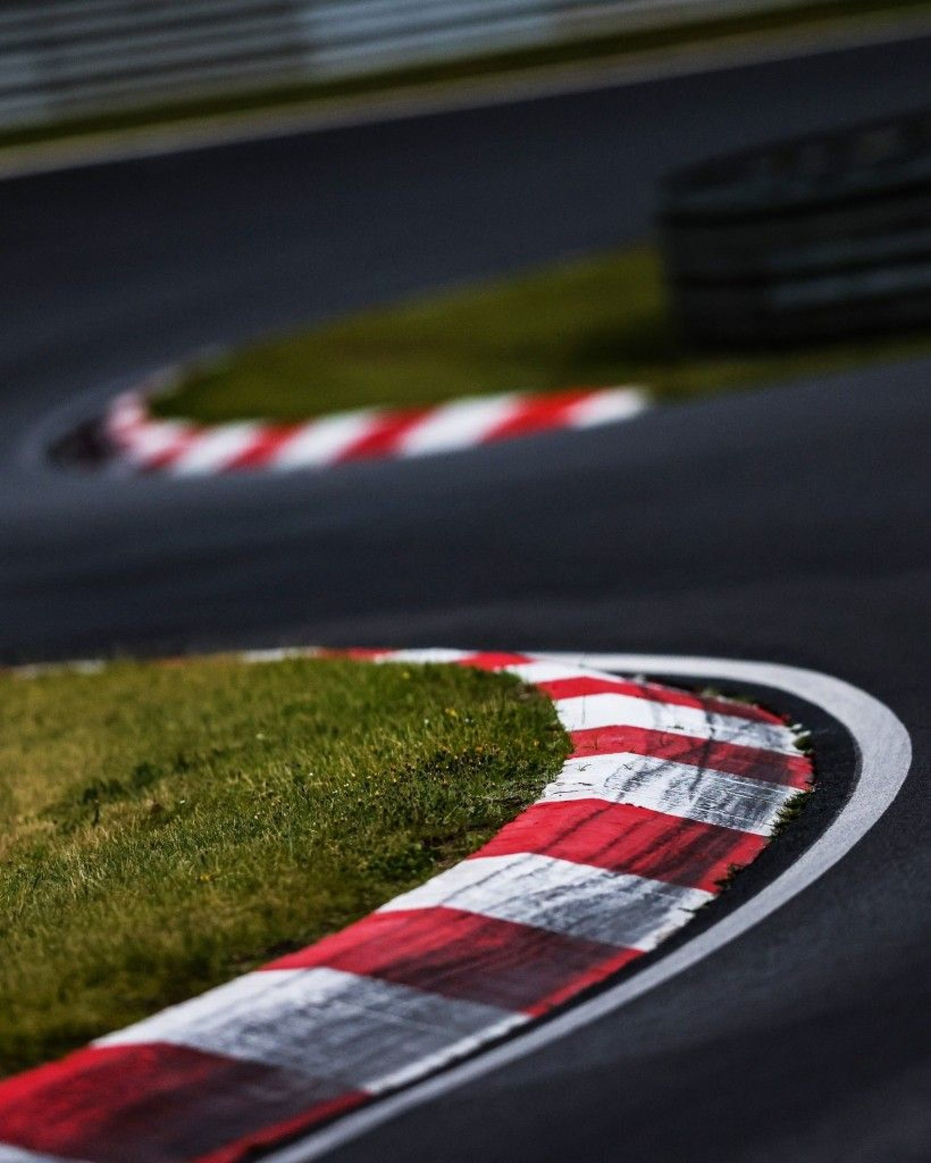 an abstract photo of a curved building with a blue sky in the background