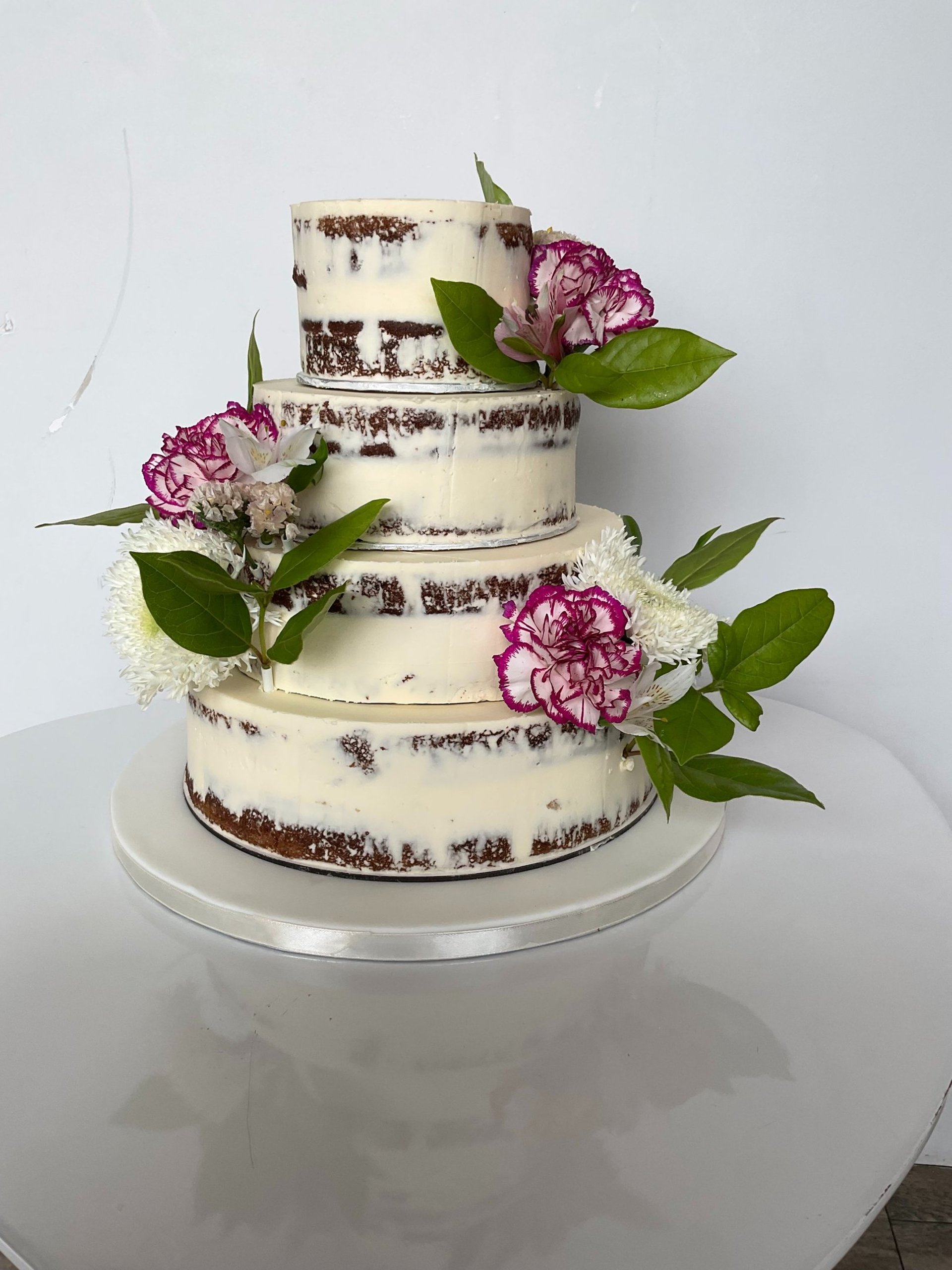white cake with chocolate syrup on white ceramic plate