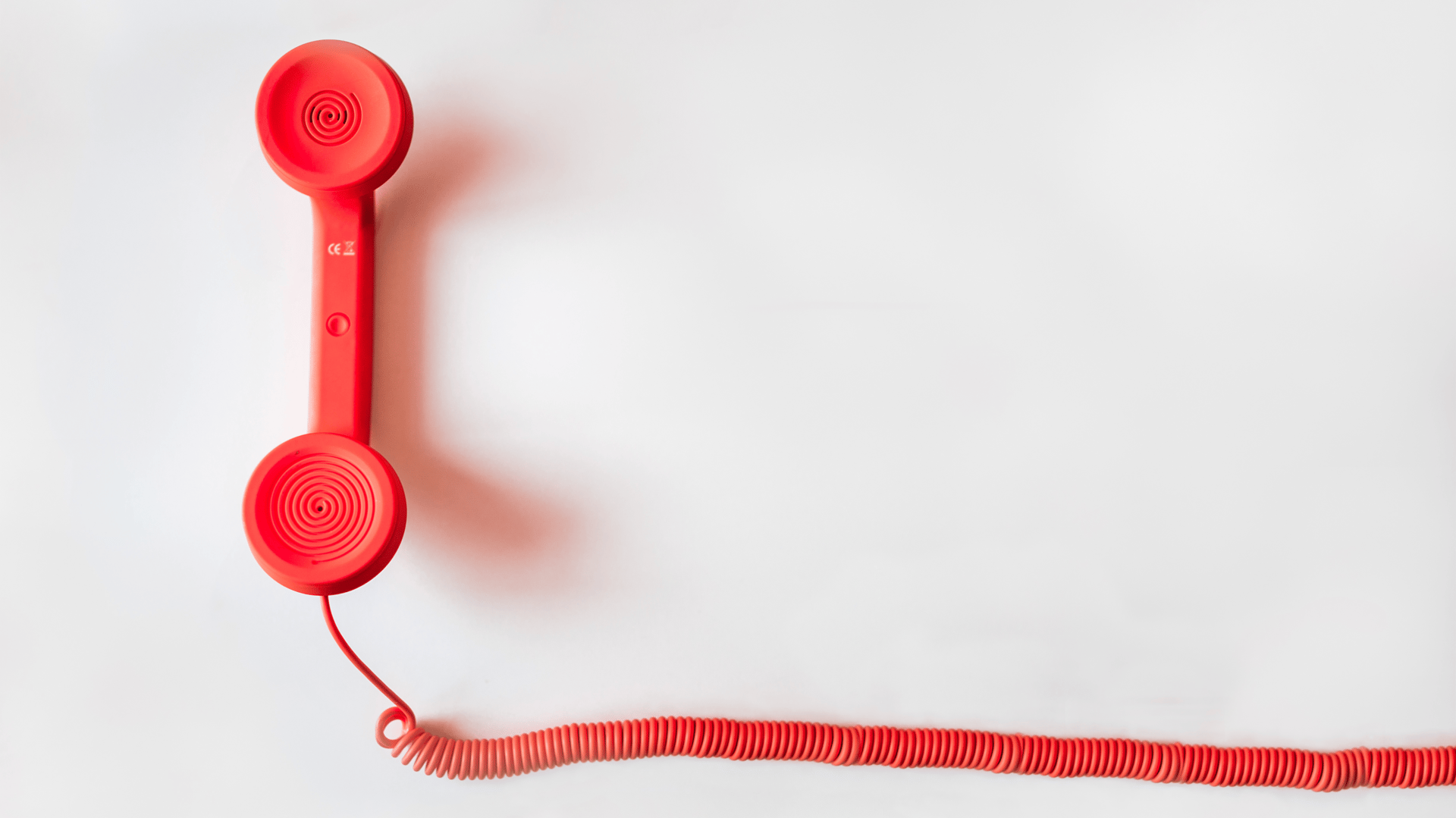 black rotary dial phone on white surface