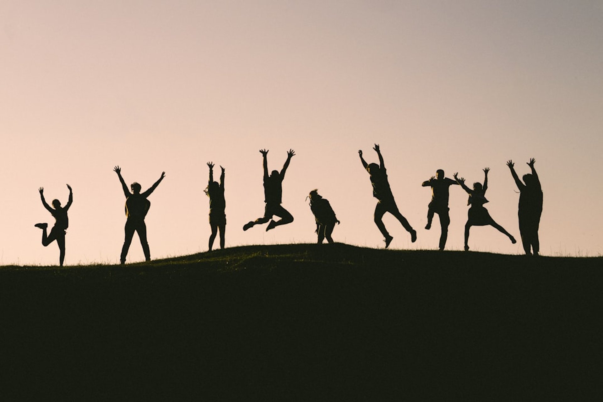 six silhouette of people jumping during sunrise