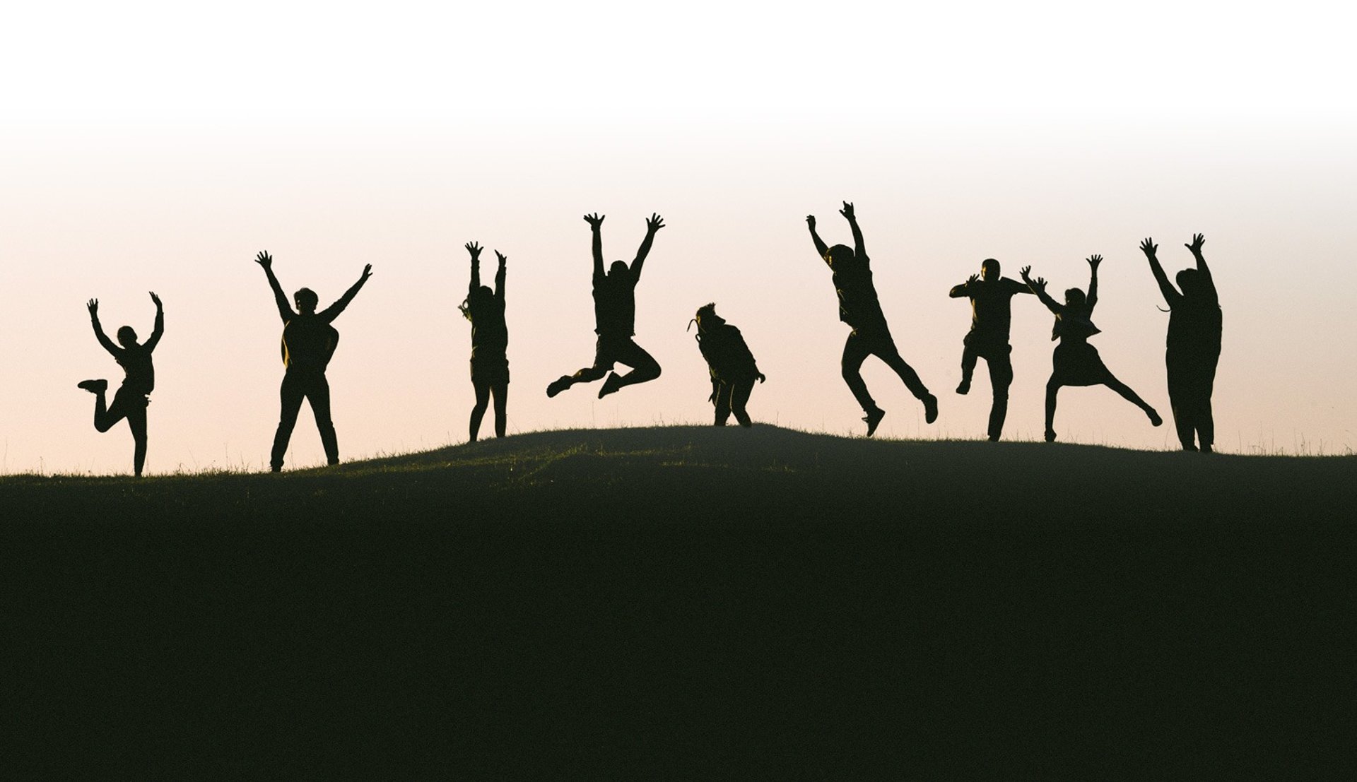 silhouette photo of group of people on mountain