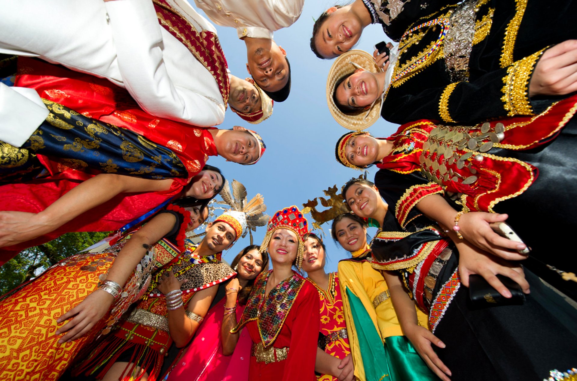 silhouette of child sitting behind tree during sunset