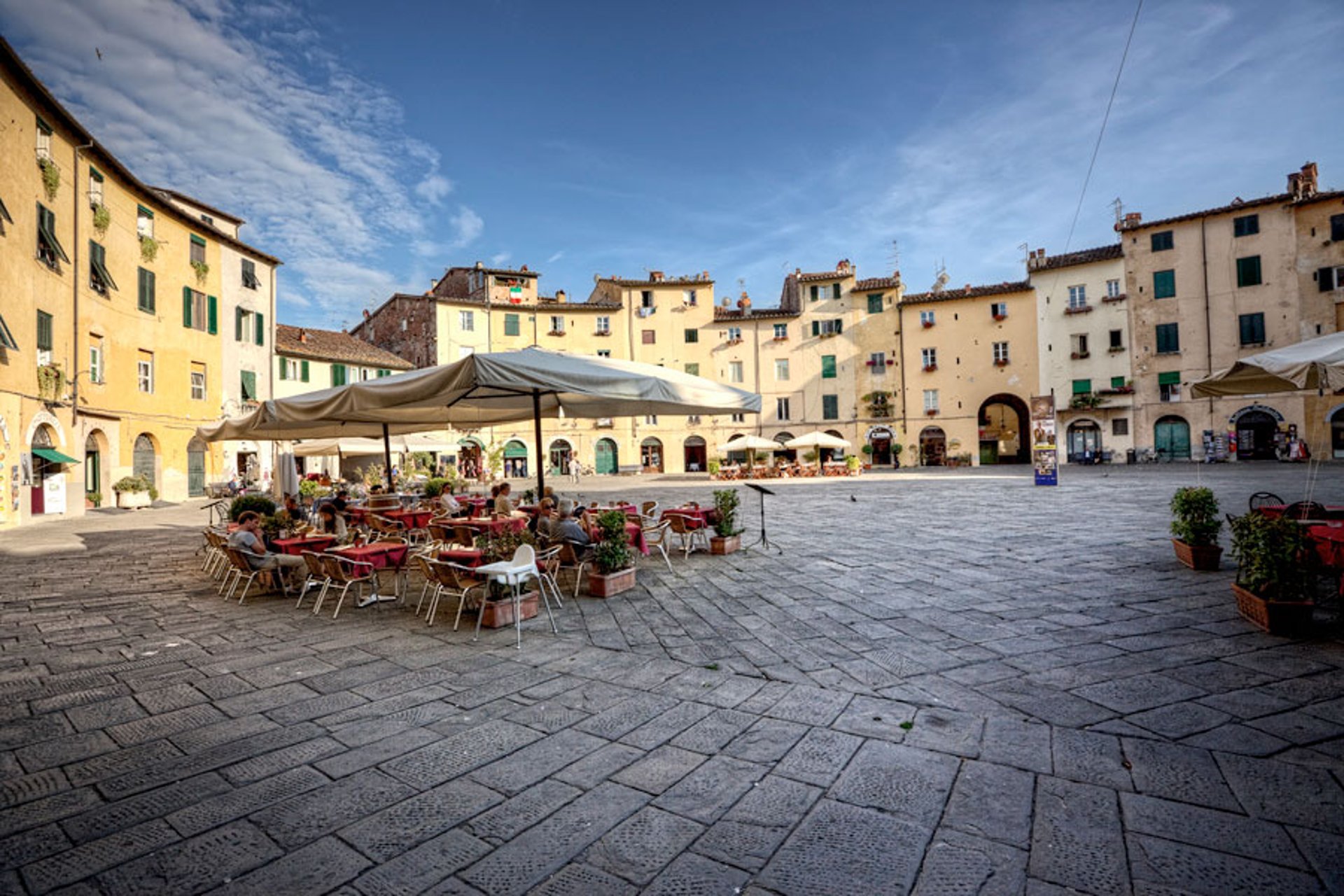 woman wearing yellow long-sleeved dress under white clouds and blue sky during daytime