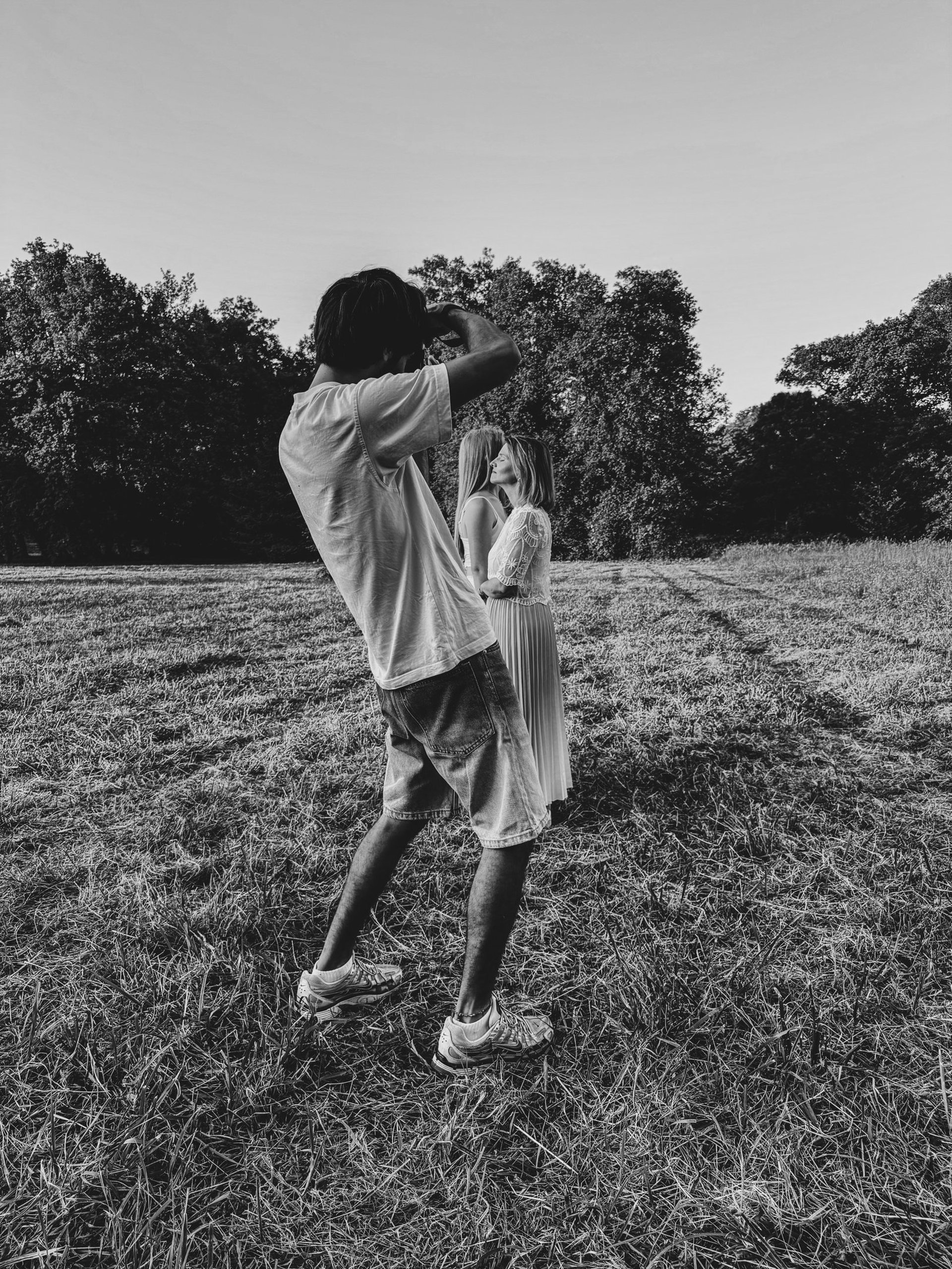 man in red jacket holding black dslr camera
