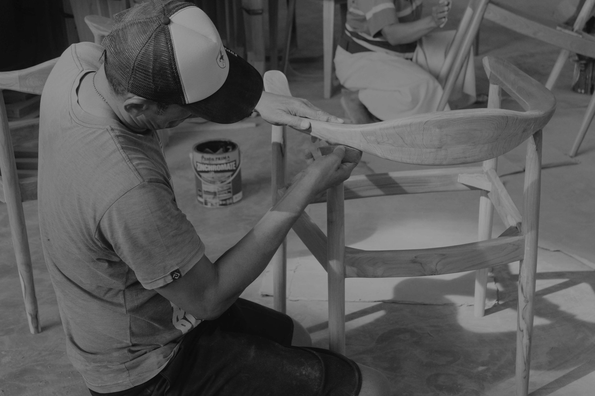 person using chisel while curving wood