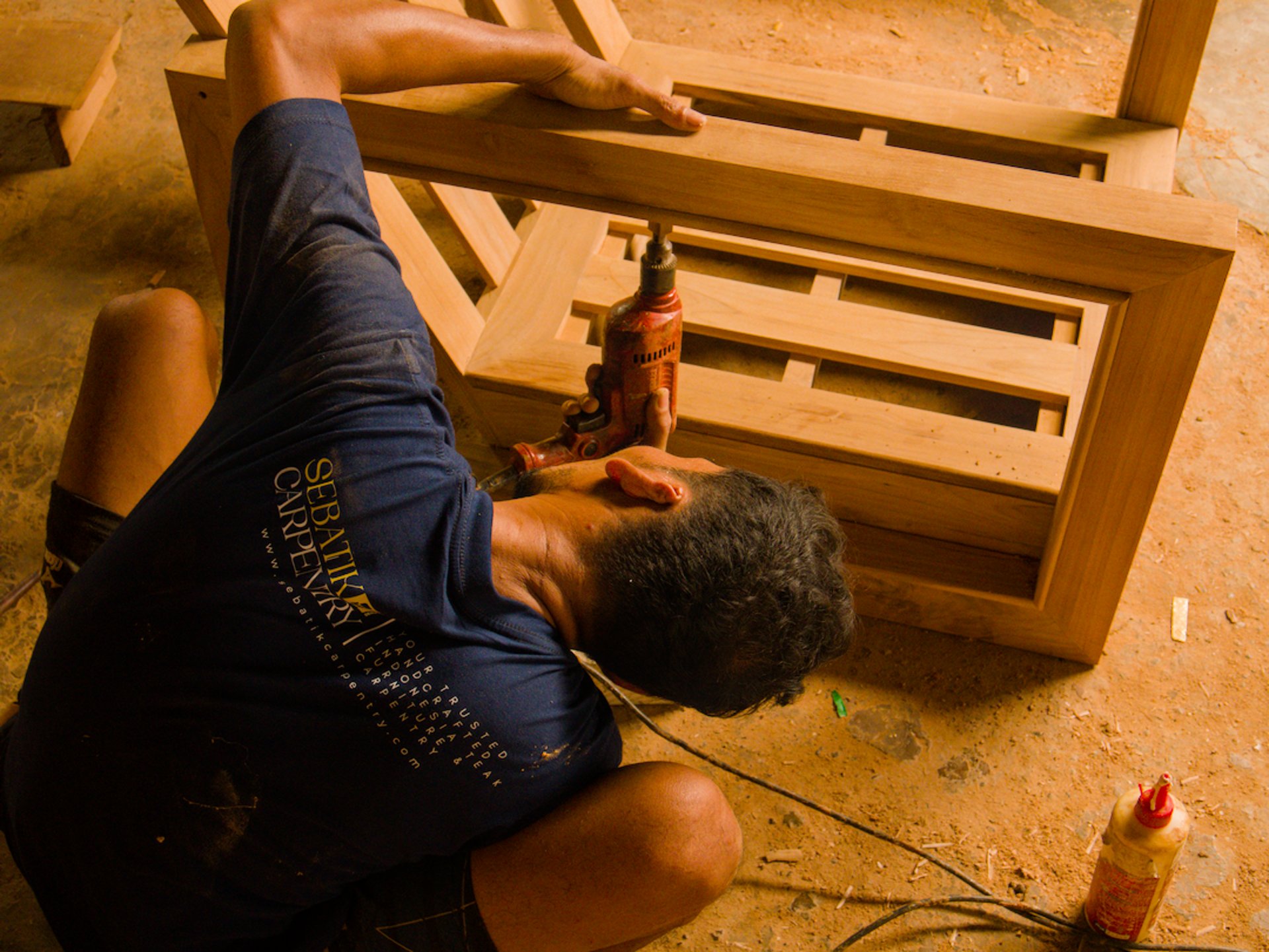 person using chisel while curving wood