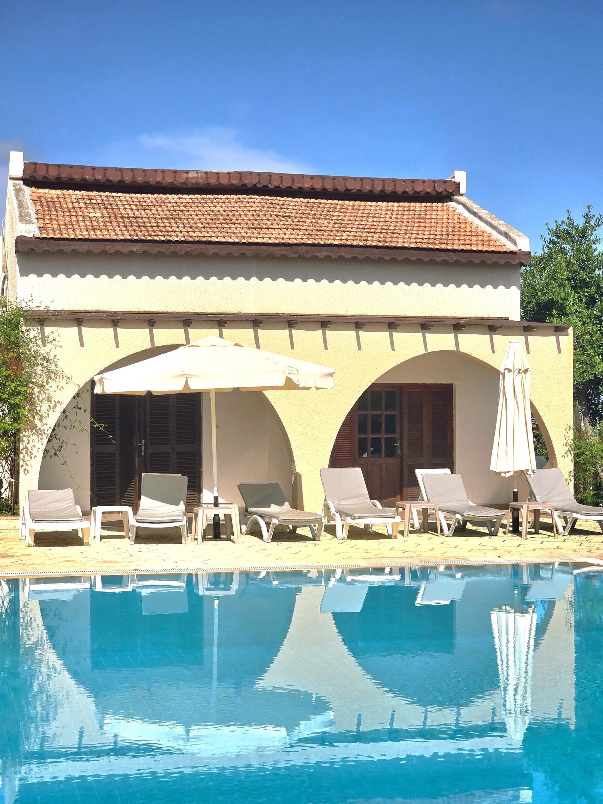 an abstract photo of a curved building with a blue sky in the background