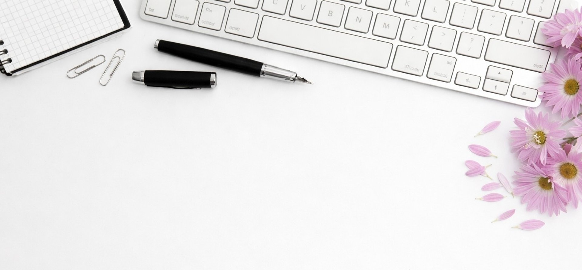 person holding notepad and pen flat lay photography