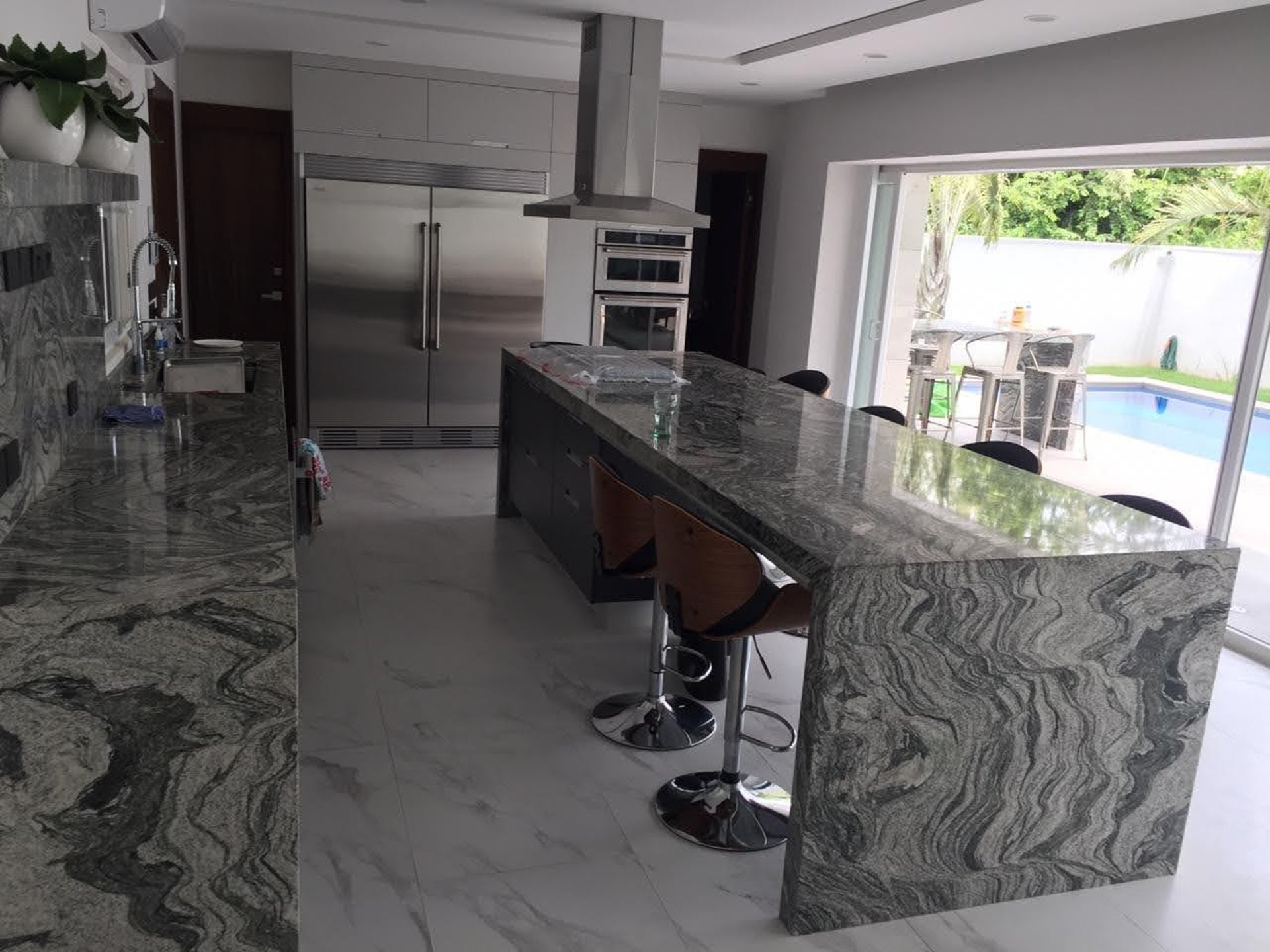 a large kitchen with a marble counter top