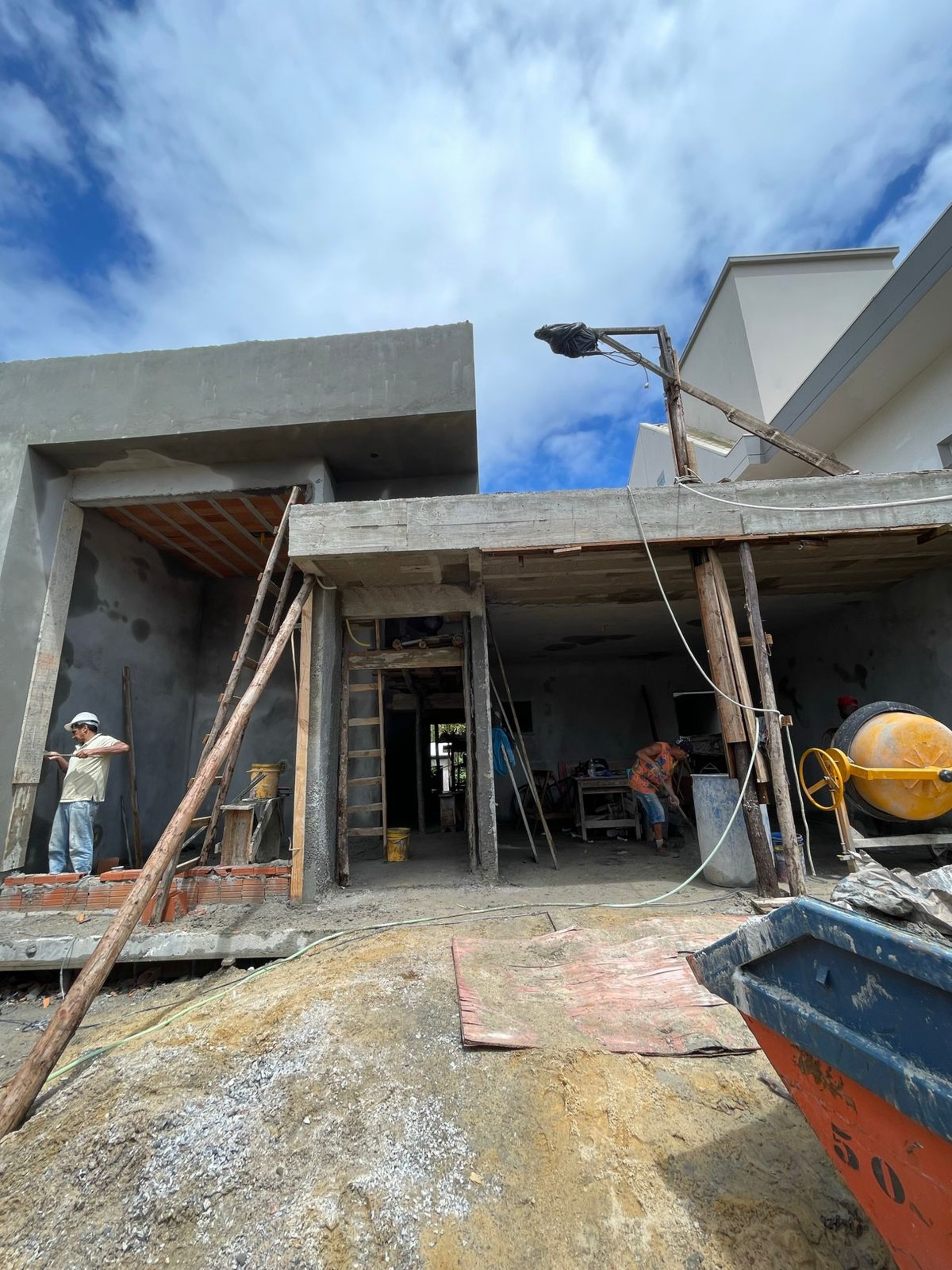 woman wearing yellow long-sleeved dress under white clouds and blue sky during daytime