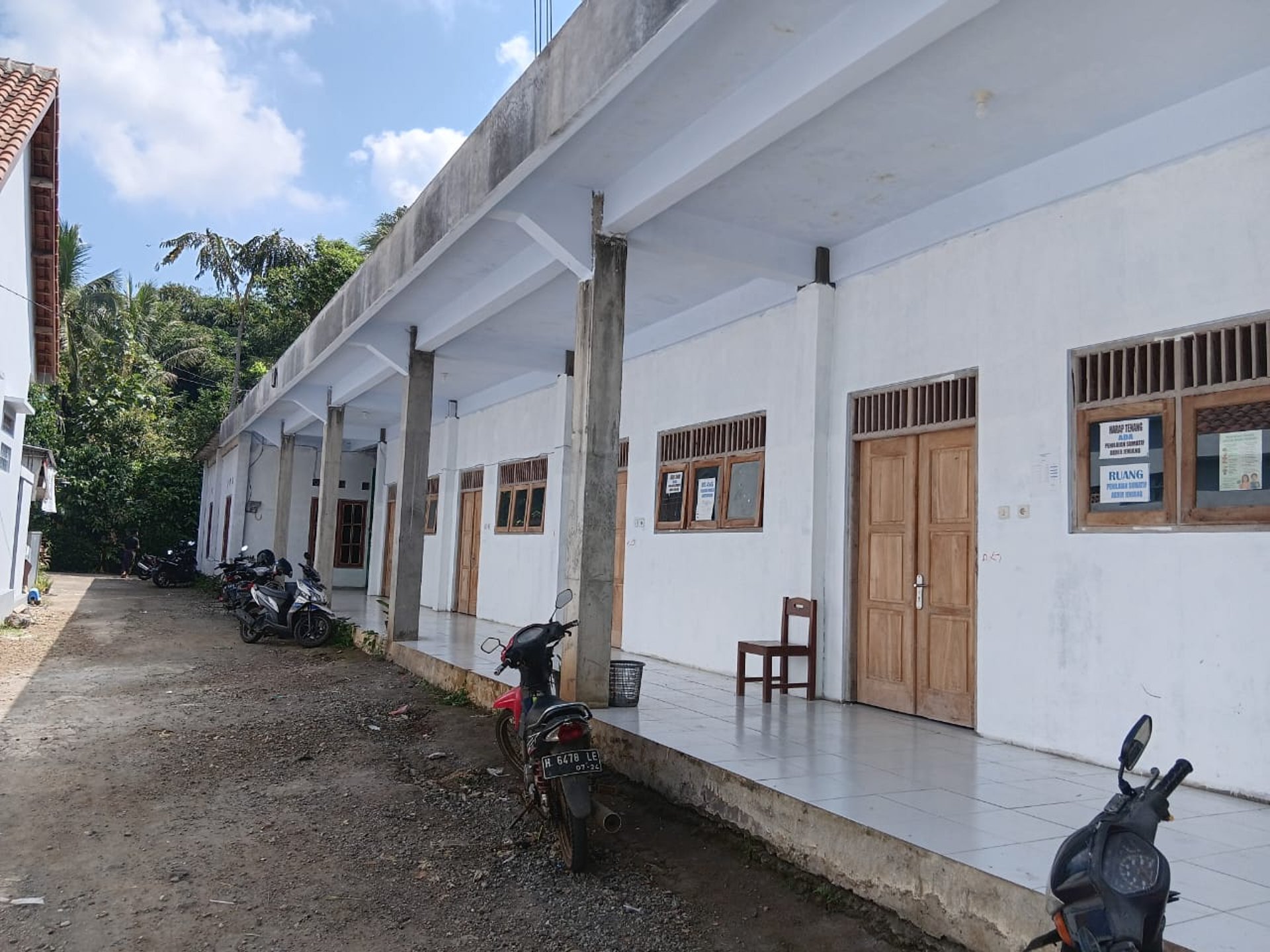 woman wearing yellow long-sleeved dress under white clouds and blue sky during daytime