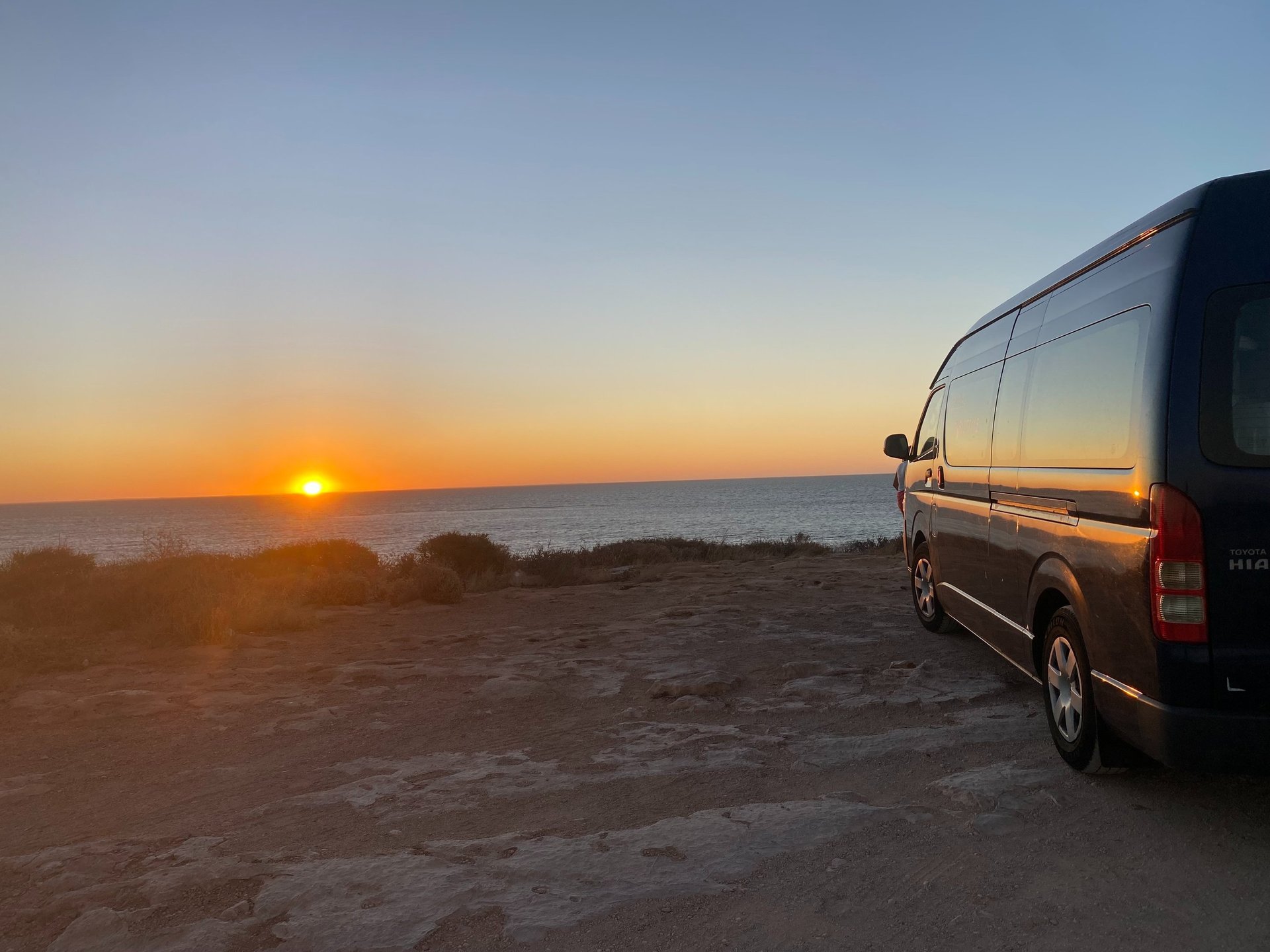 woman wearing yellow long-sleeved dress under white clouds and blue sky during daytime