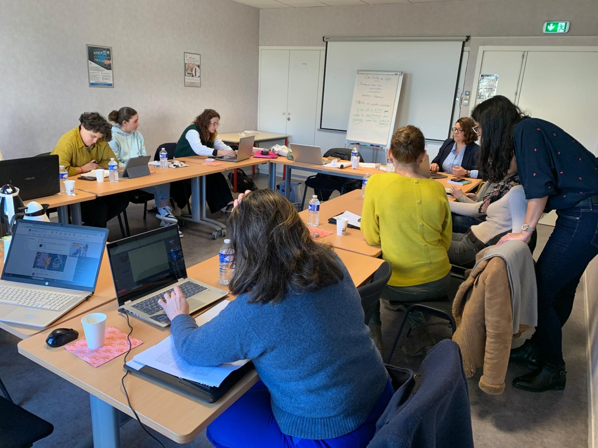 woman in blue long sleeve shirt sitting on brown couch