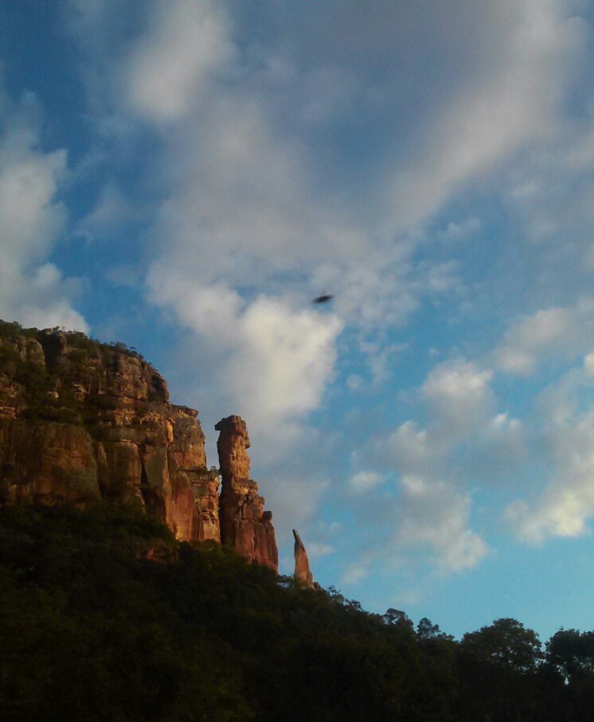 five persons riding camels walking on sand beside Pyramid of Egypt