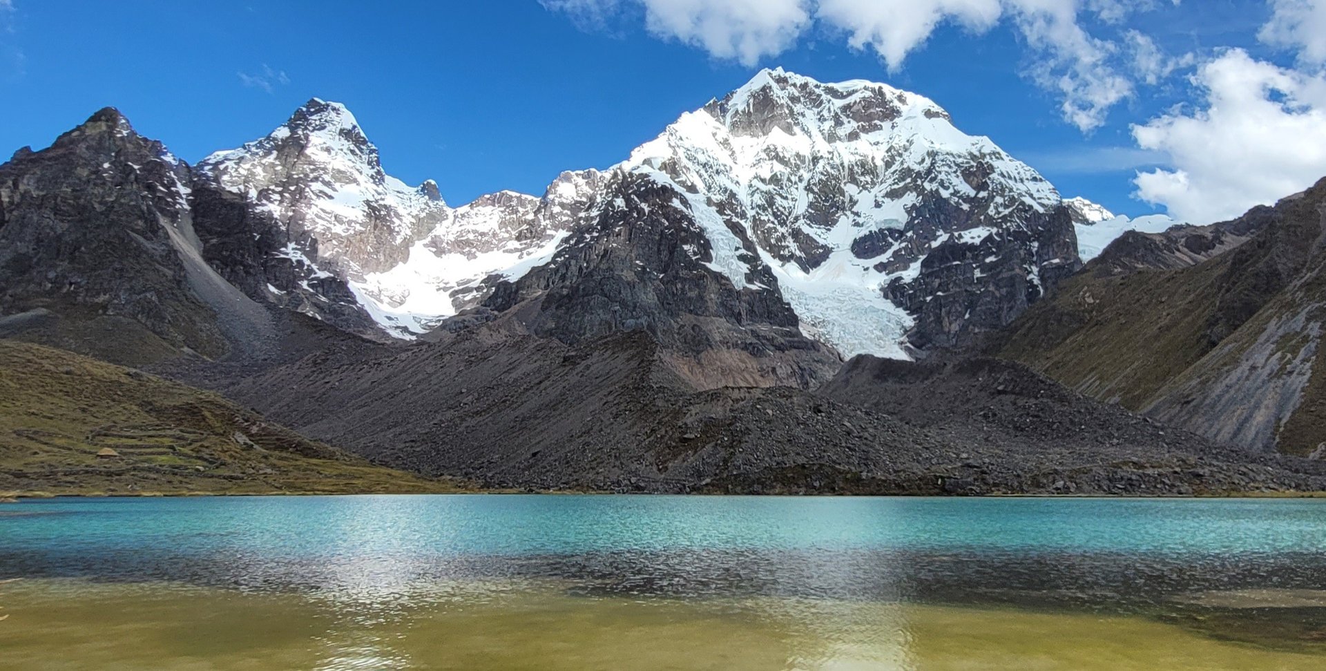 Glacial lake and mountains under blue sky