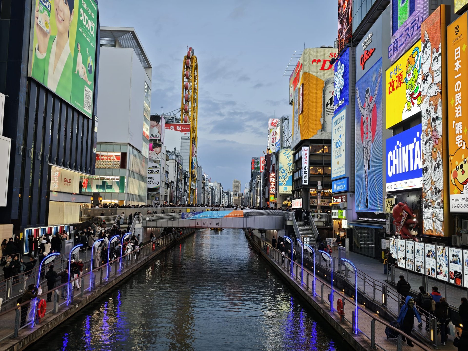 brown boat on river near green and brown building during daytime
