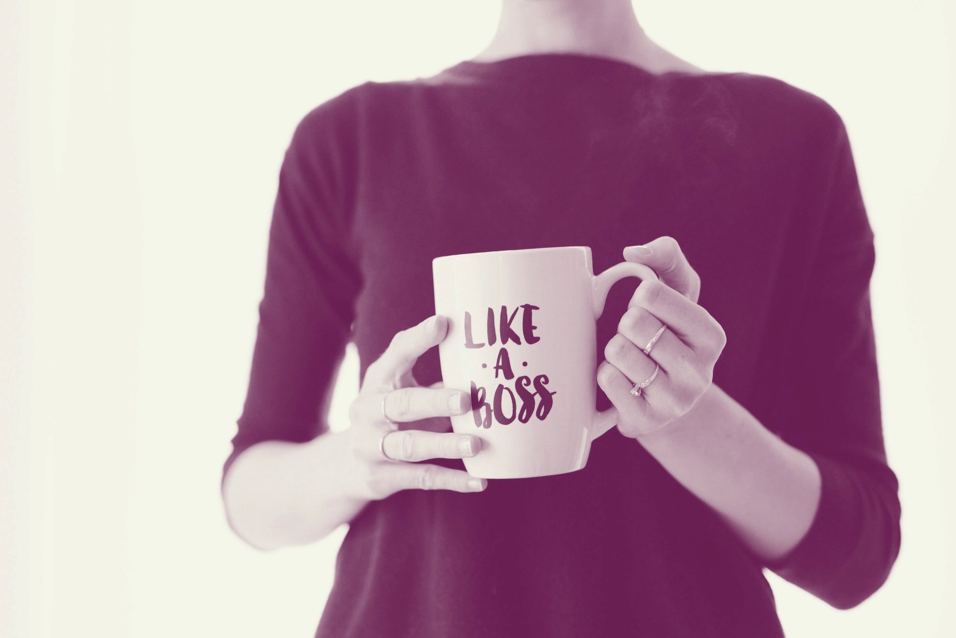 A woman holding a "Like A Boss" mug