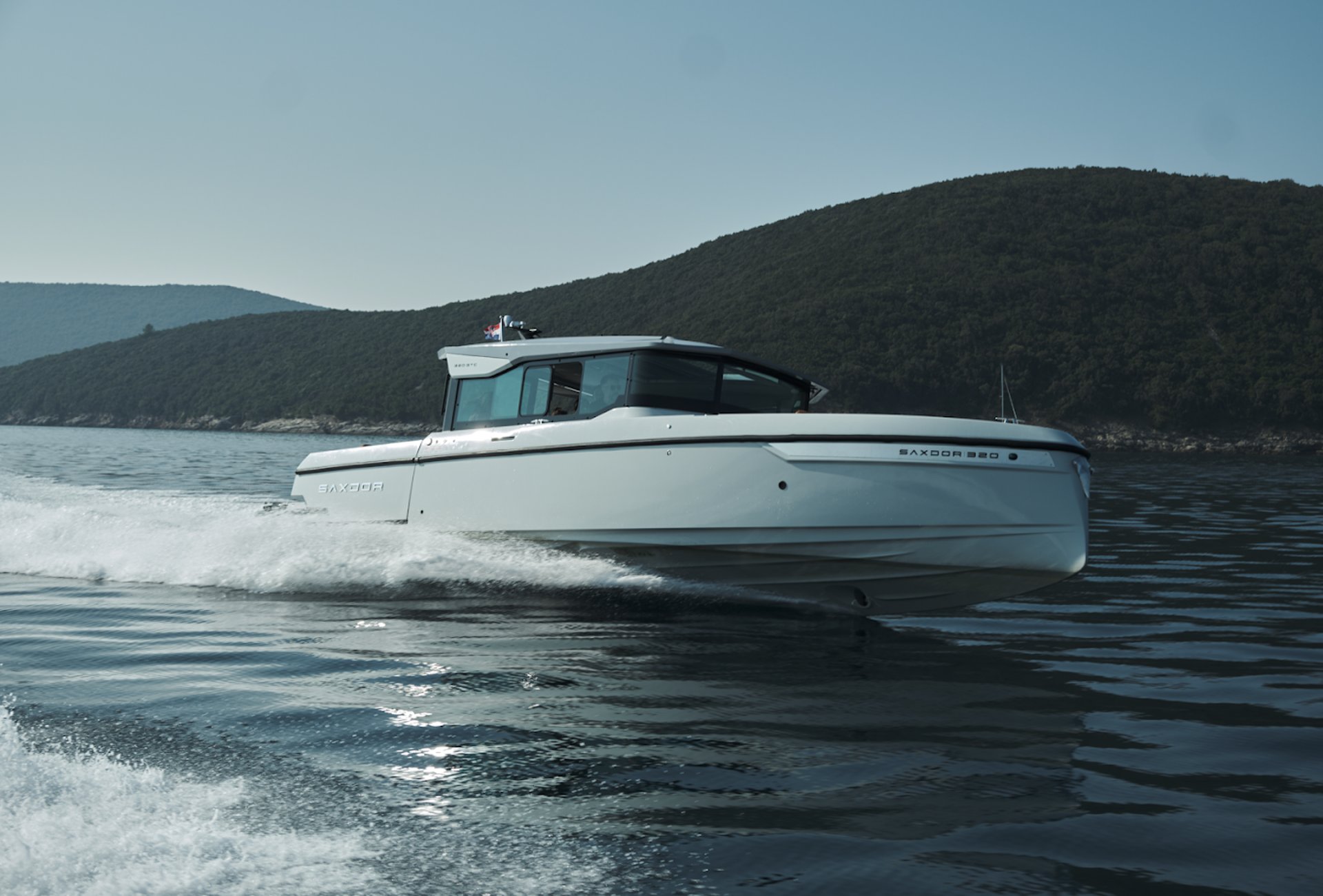 Speedboat floating on the water in full speed.