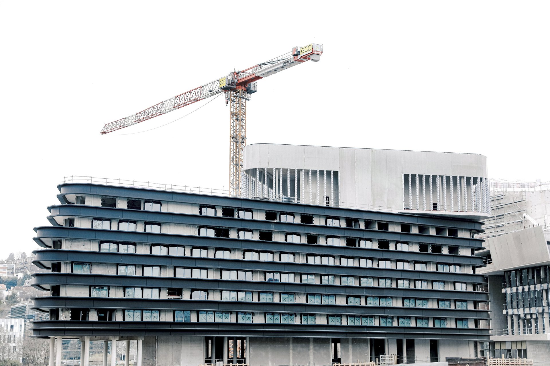 an abstract photo of a curved building with a blue sky in the background