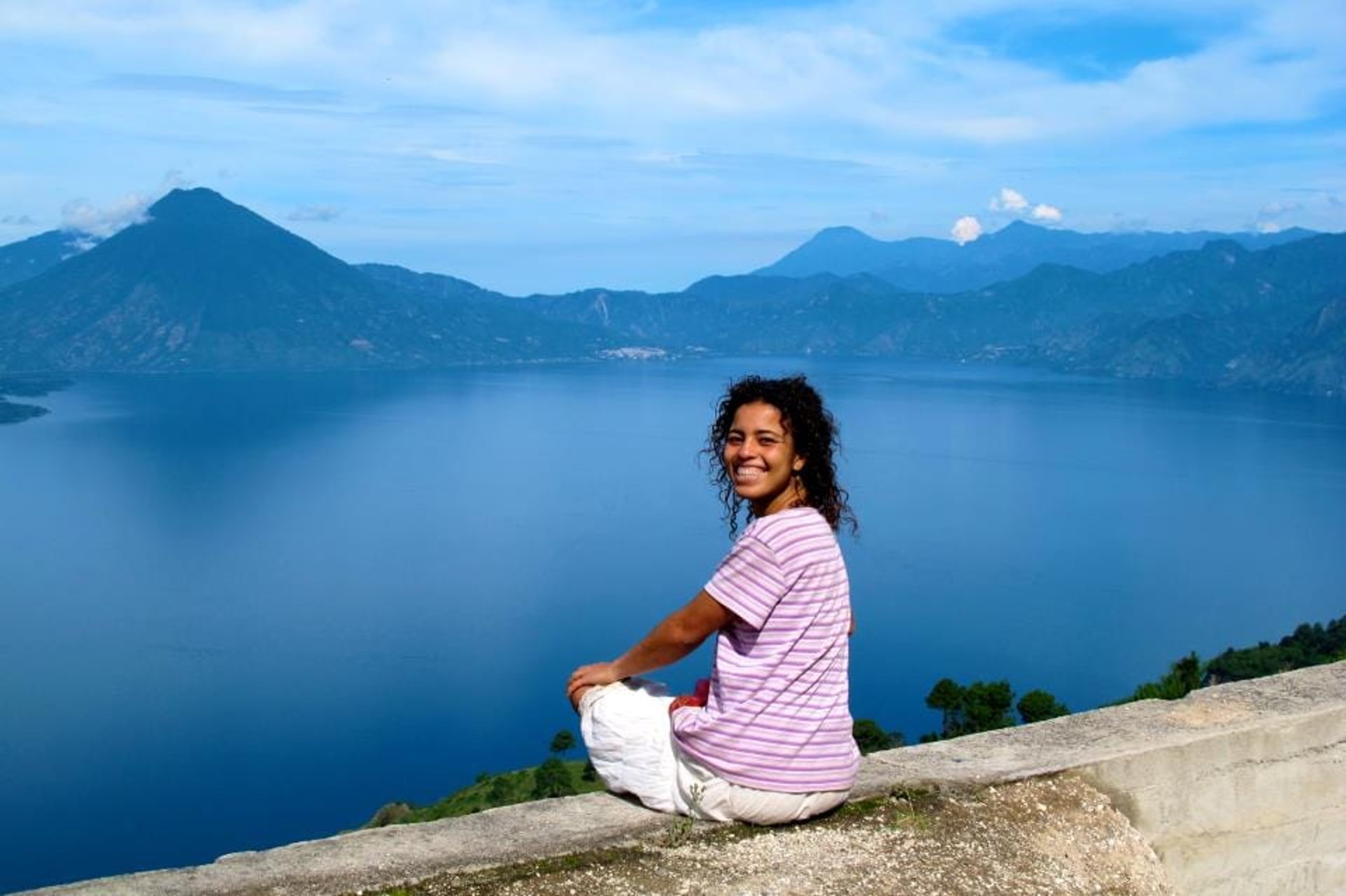 woman wearing yellow long-sleeved dress under white clouds and blue sky during daytime