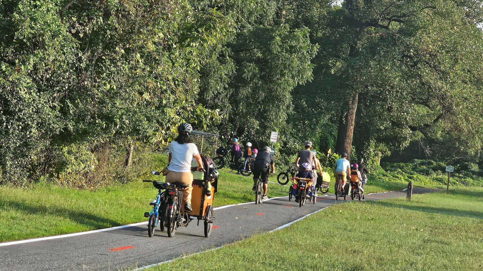 man in blue shirt riding bicycle on road during daytime