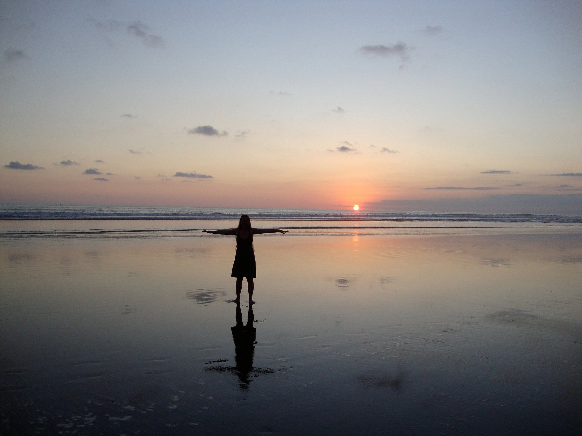 woman wearing yellow long-sleeved dress under white clouds and blue sky during daytime
