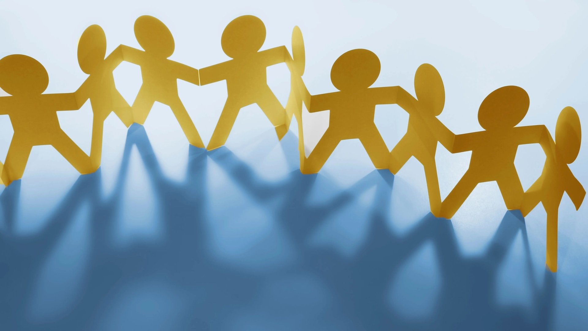 people holding shoulders sitting on wall