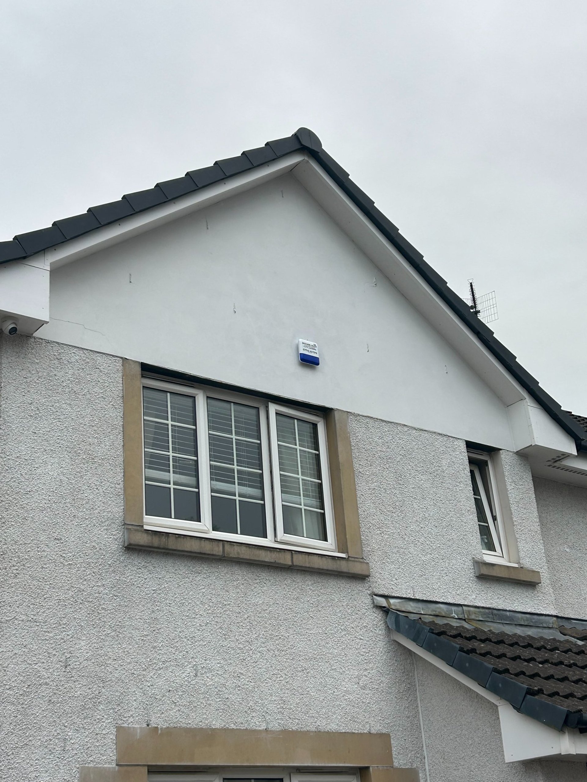 three white CCTV cameras mounted on wall