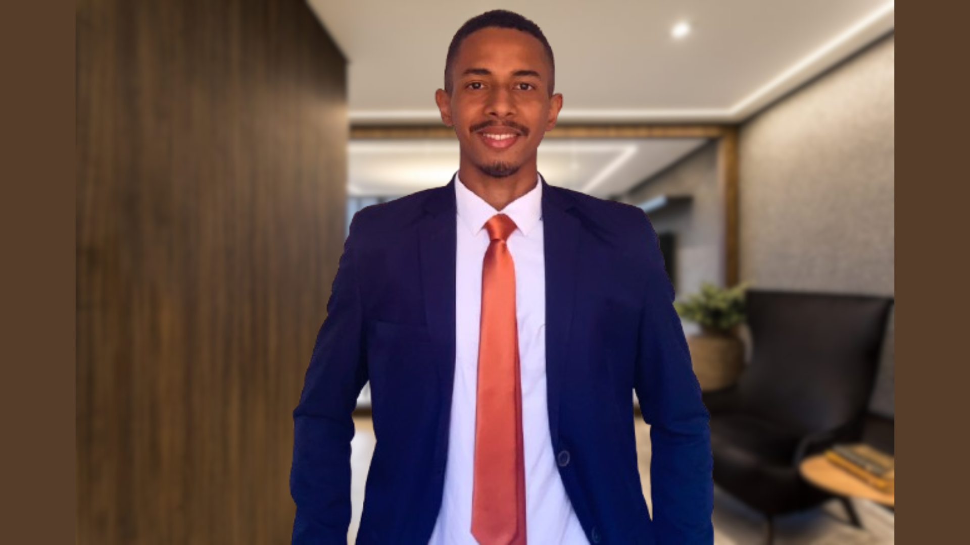 a man in a blue suit holding a smart phone
