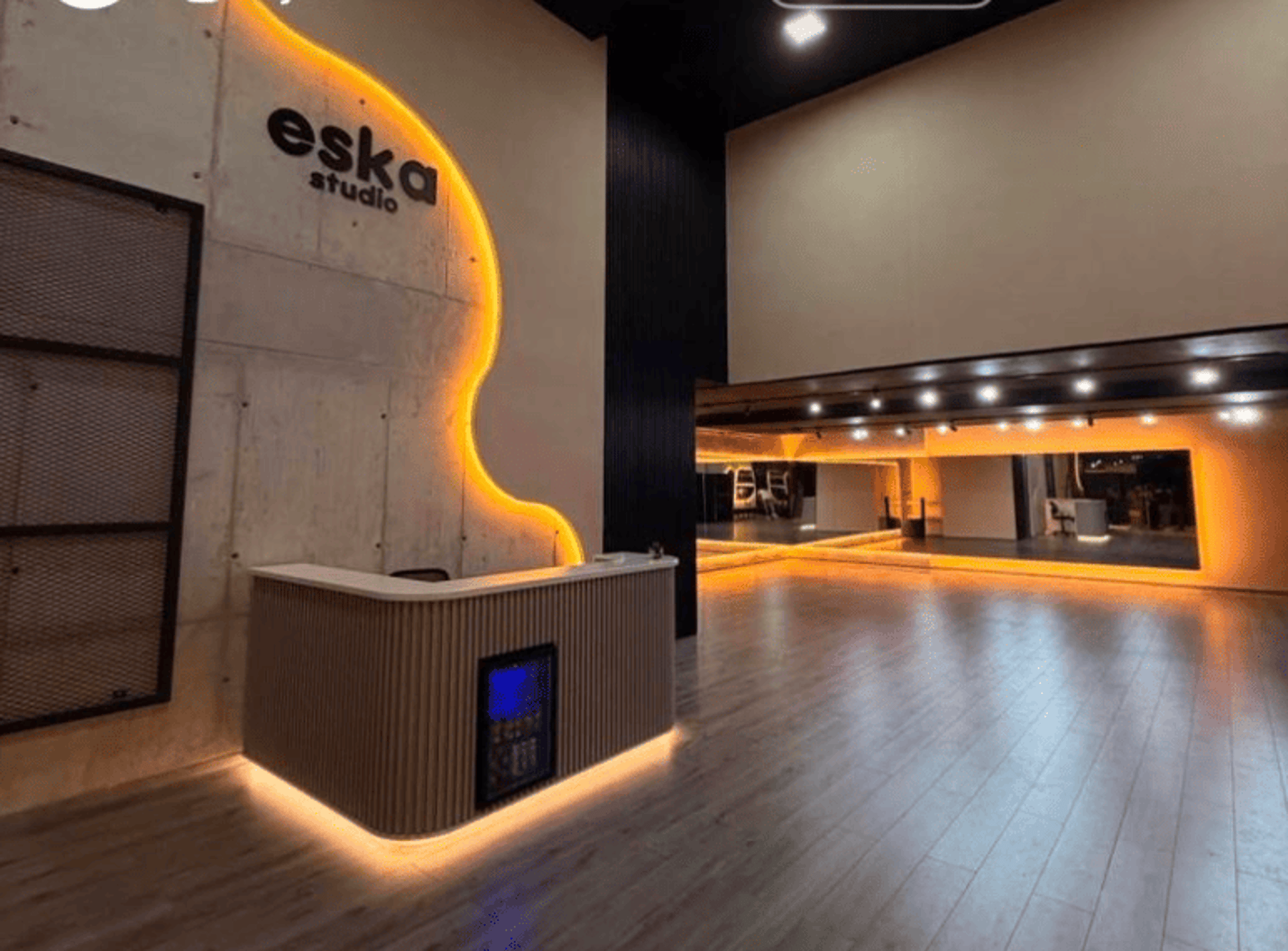 an abstract photo of a curved building with a blue sky in the background