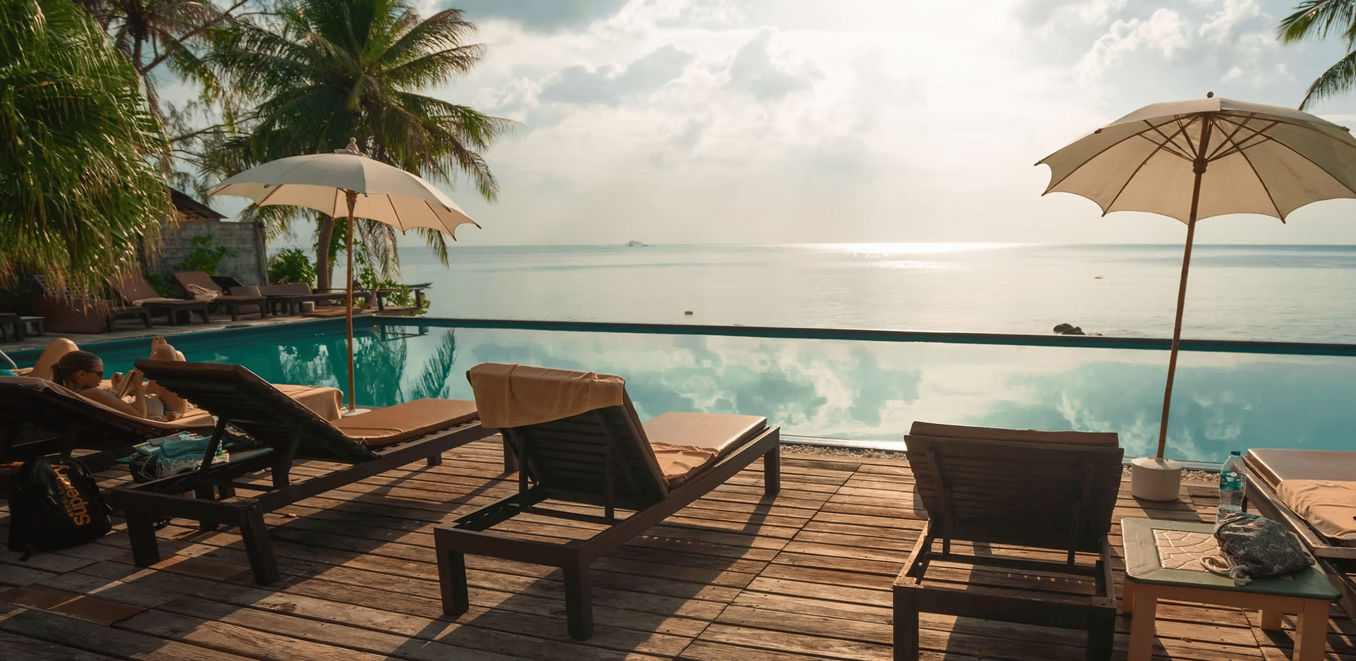 a large swimming pool surrounded by palm trees