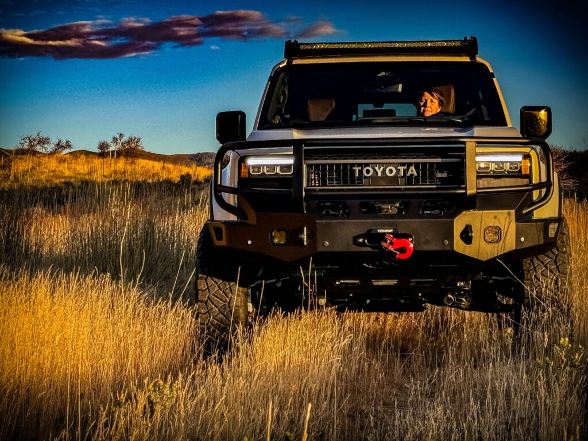 a black toyota land cruiser parked in front of a building