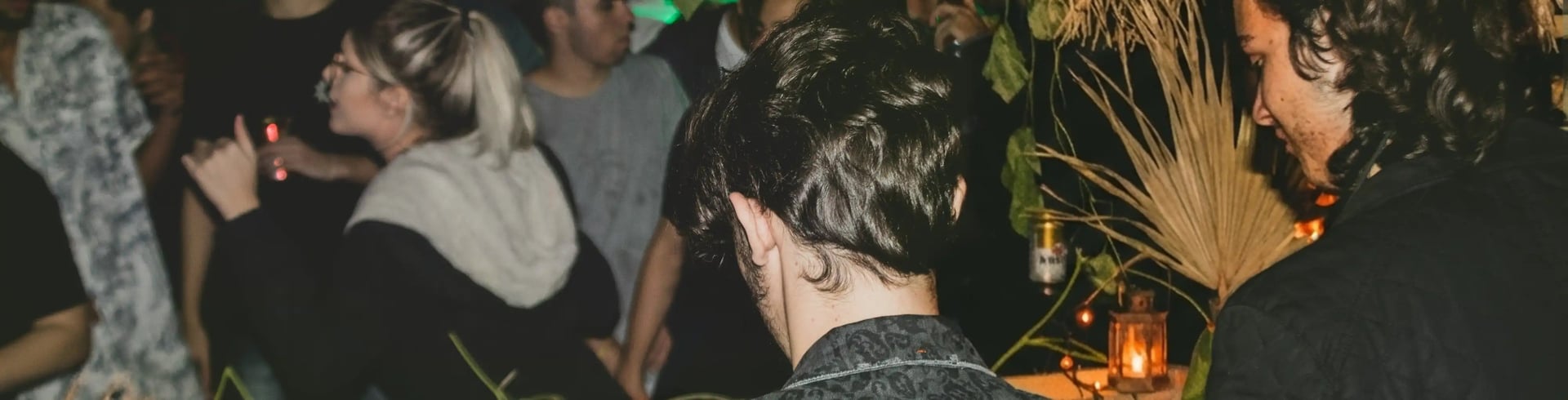 Woman in a white top and jeans at night