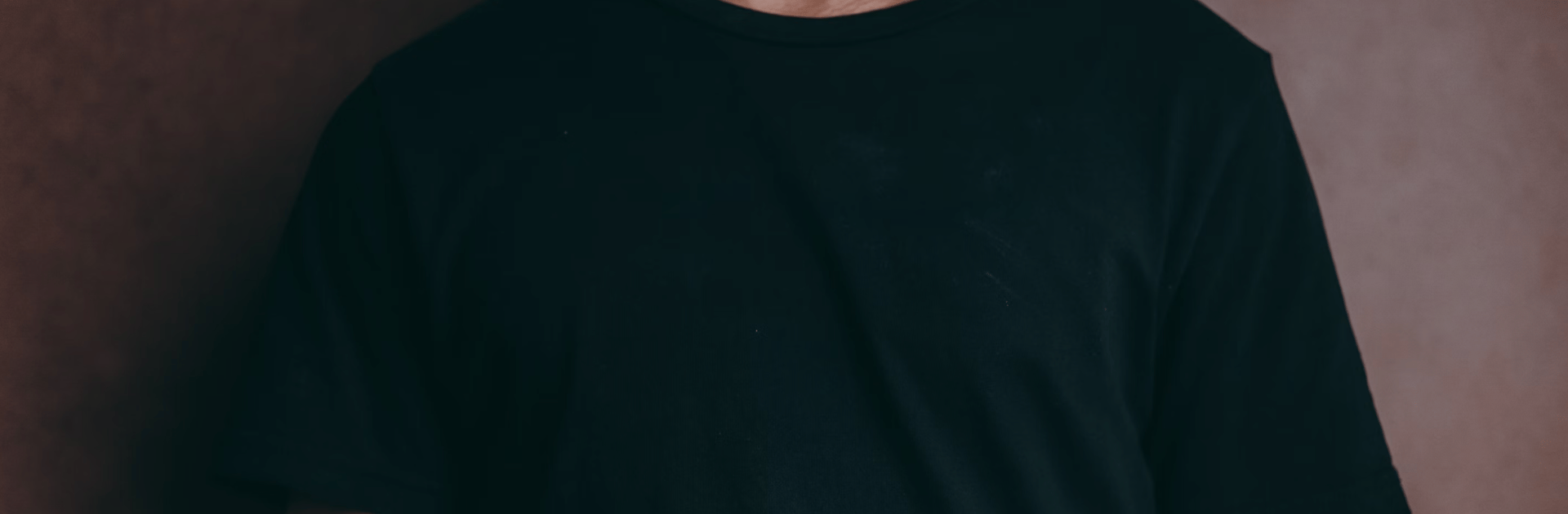 man wearing black crew-neck t-shirt