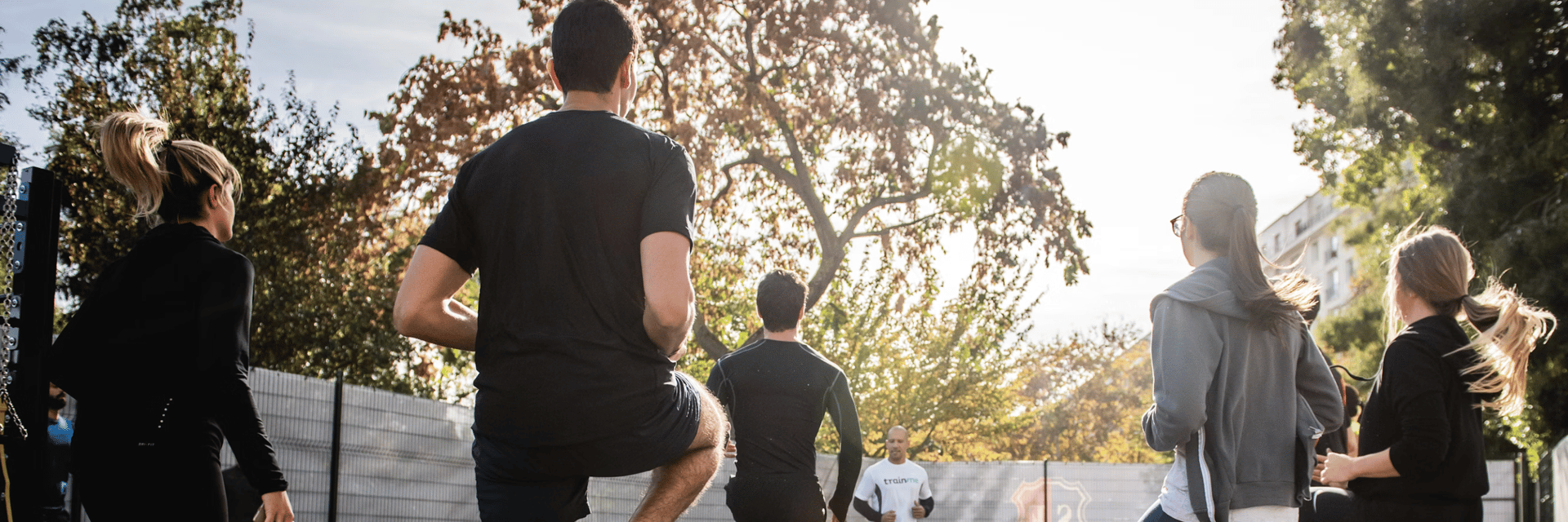 man in black t-shirt and black shorts running on road during daytime