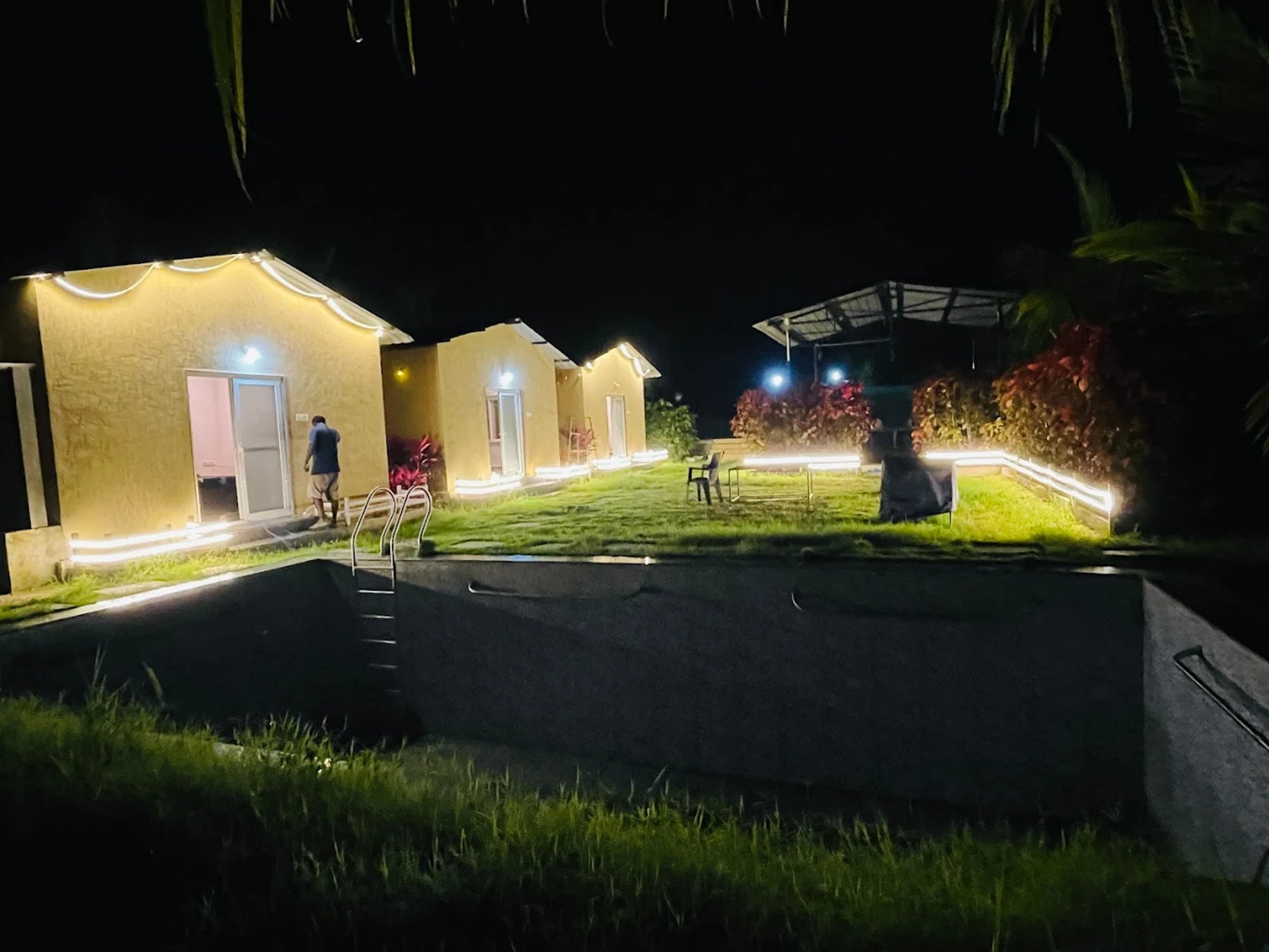 low-angle photo of Hotel lighted signage on top of brown building during nighttime
