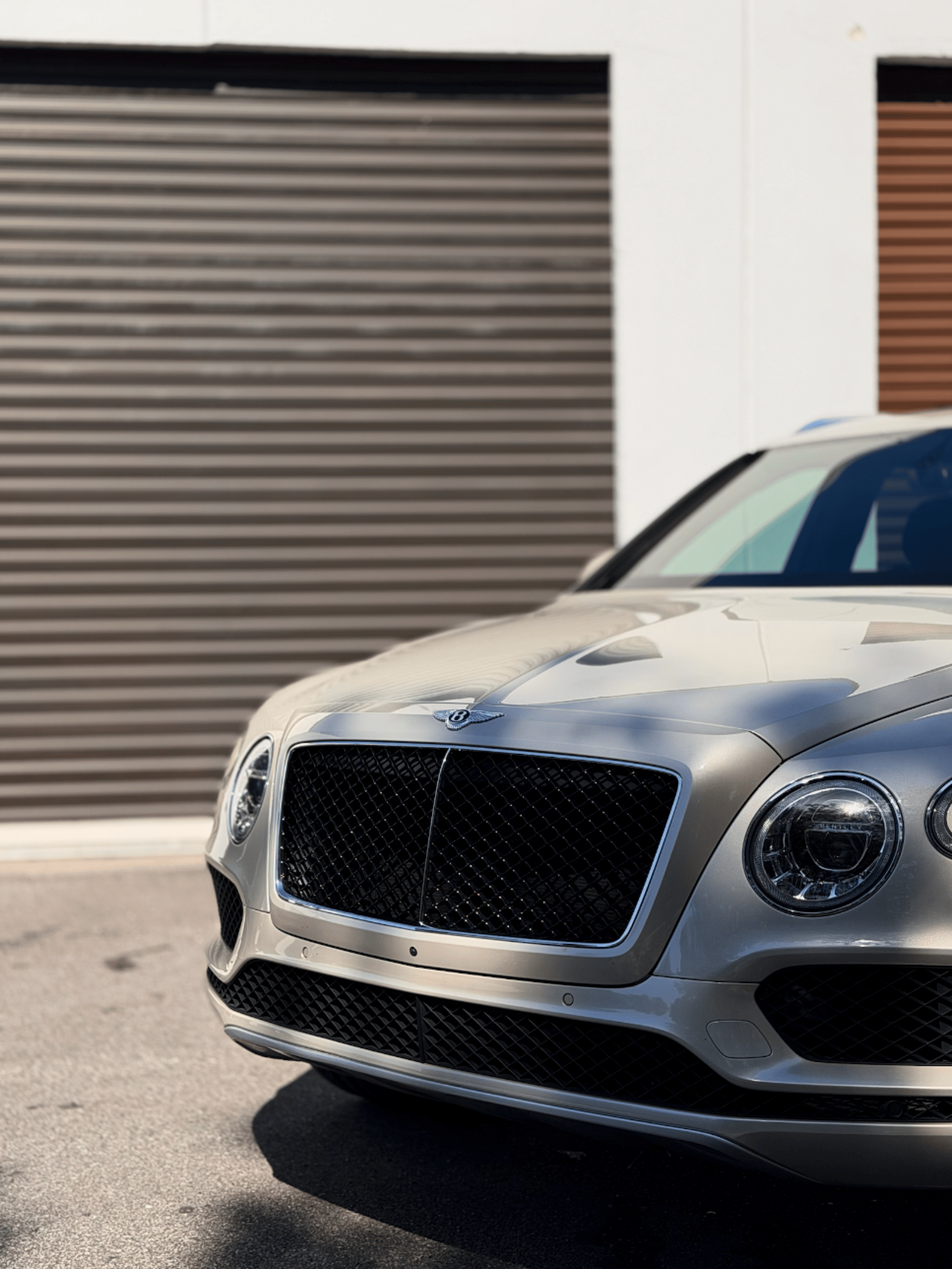 a black suv parked in front of a building
