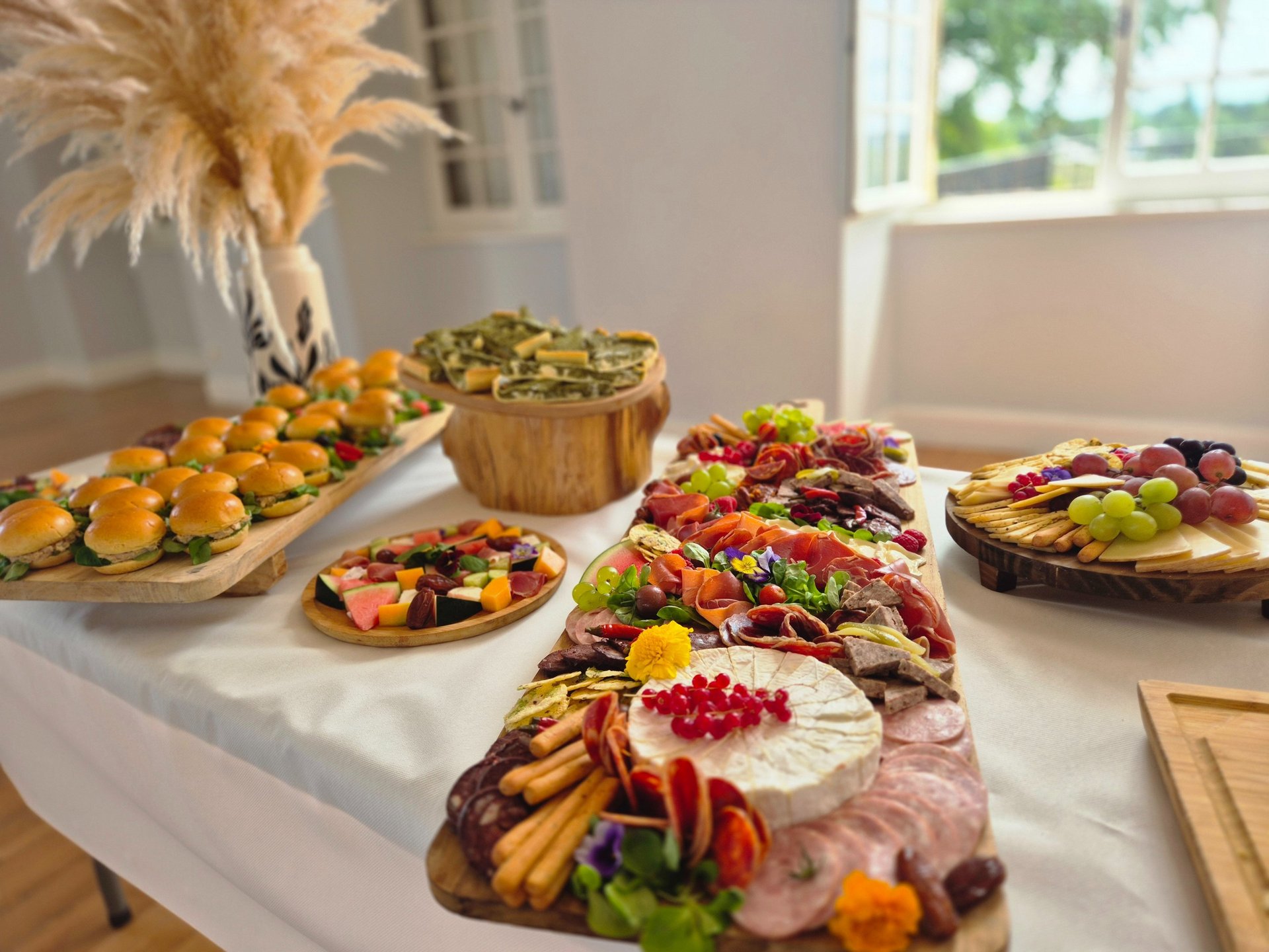 a table topped with plates of food and a vase filled with flowers