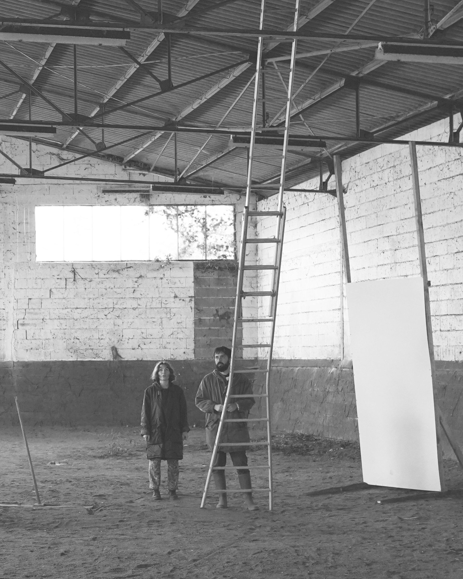 an abstract photo of a curved building with a blue sky in the background