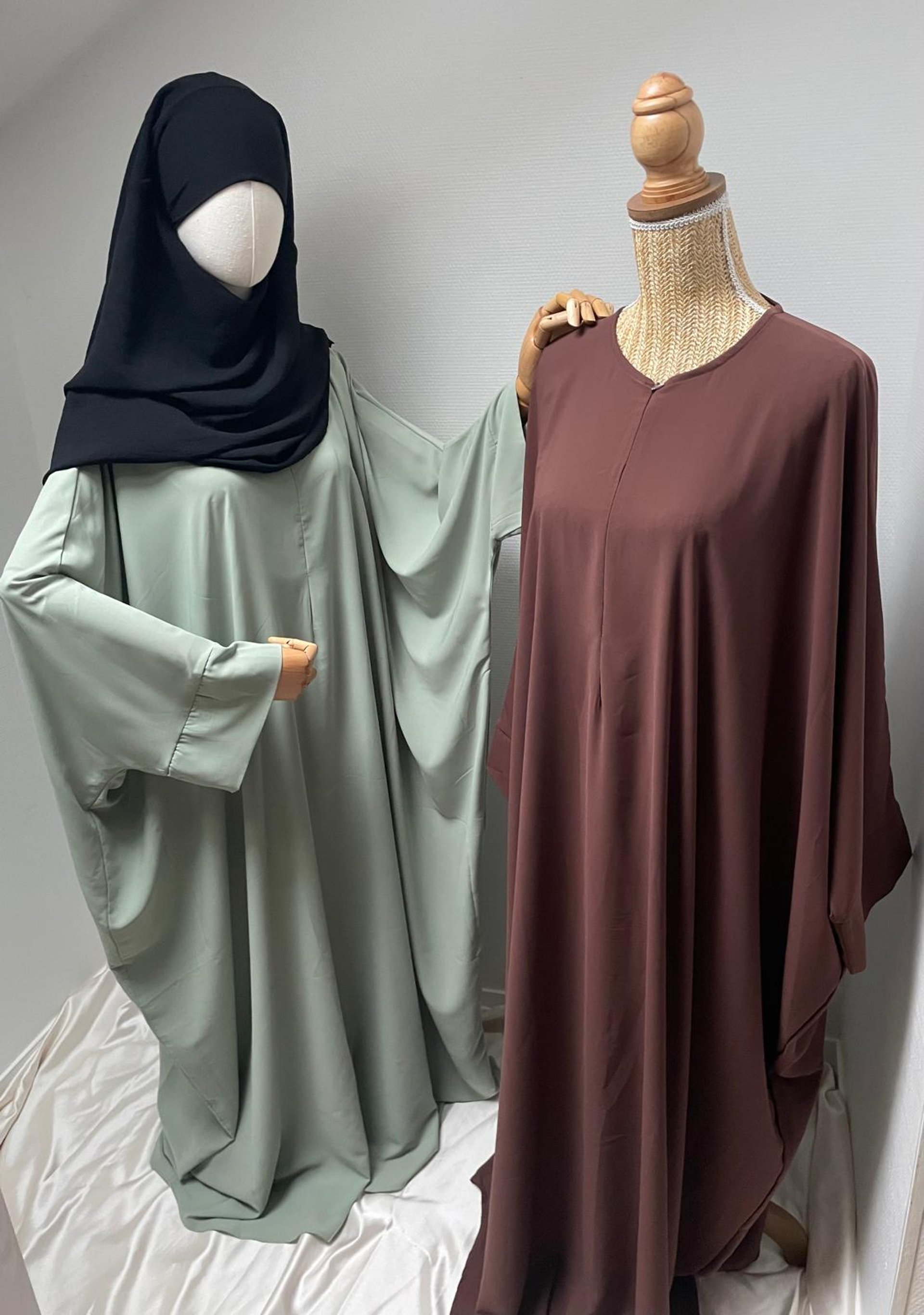 hanged top on brown and white clothes horse