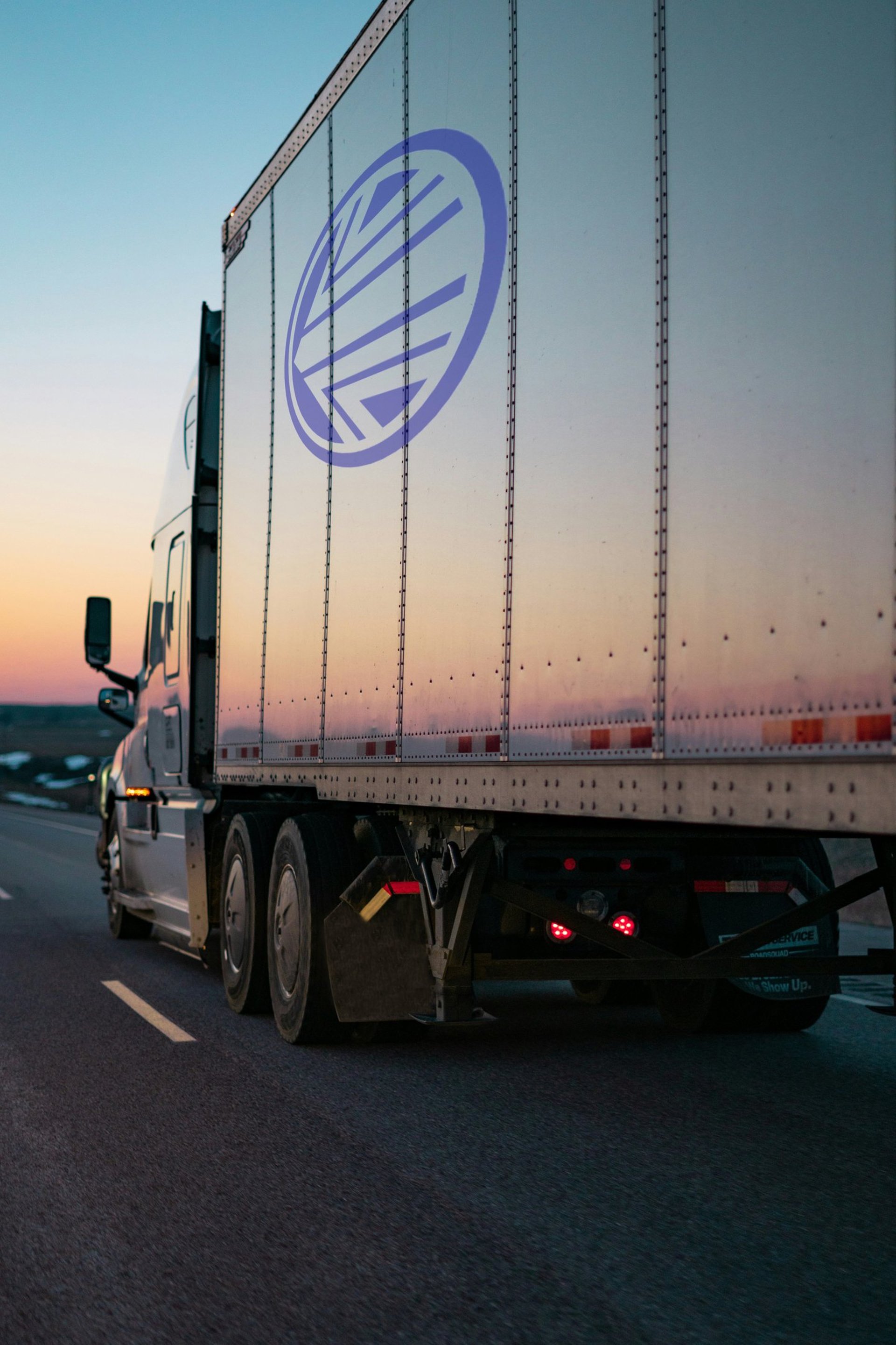 white freight truck on road during daytime