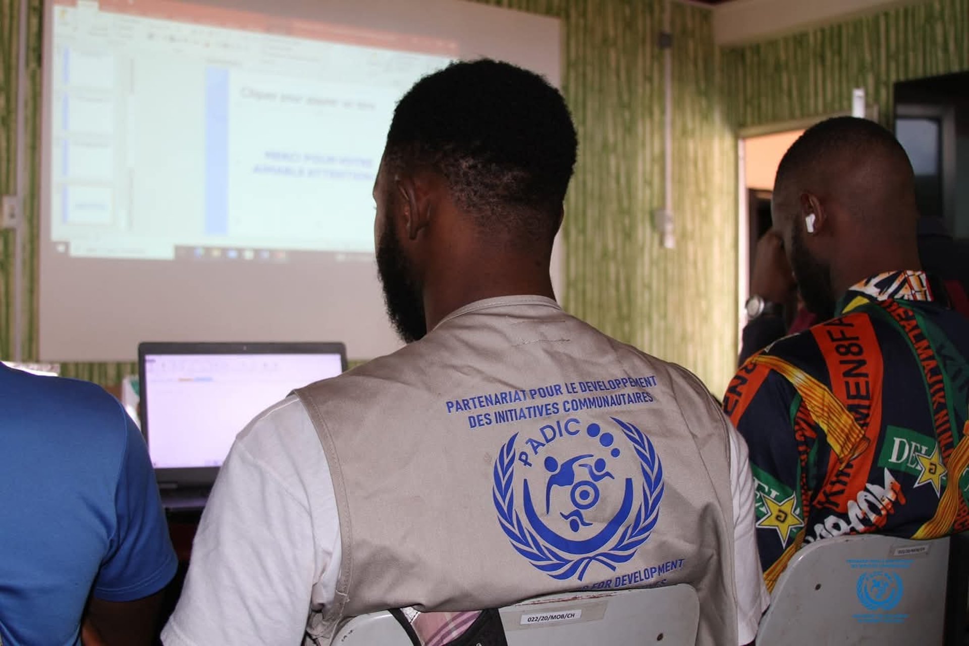 man wearing gray polo shirt beside dry-erase board