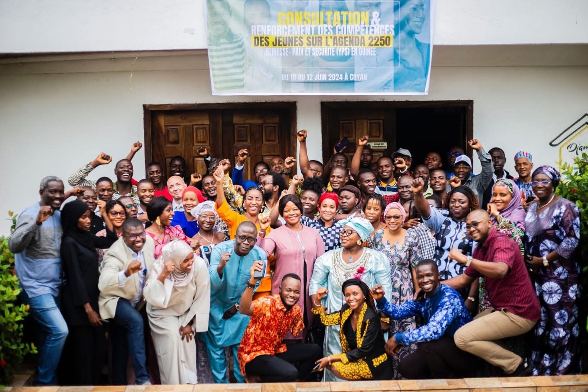 person in green shirt wearing black knit cap