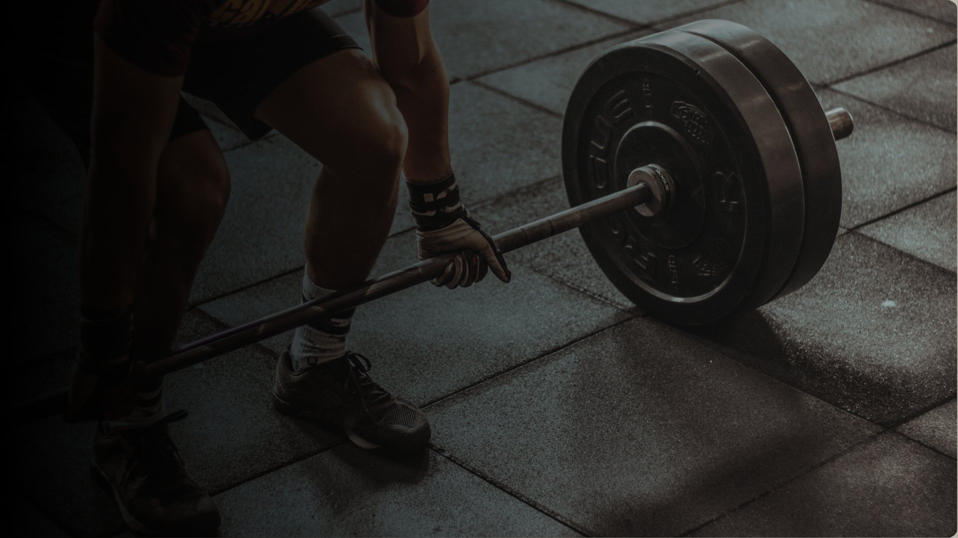 person holding black barbell