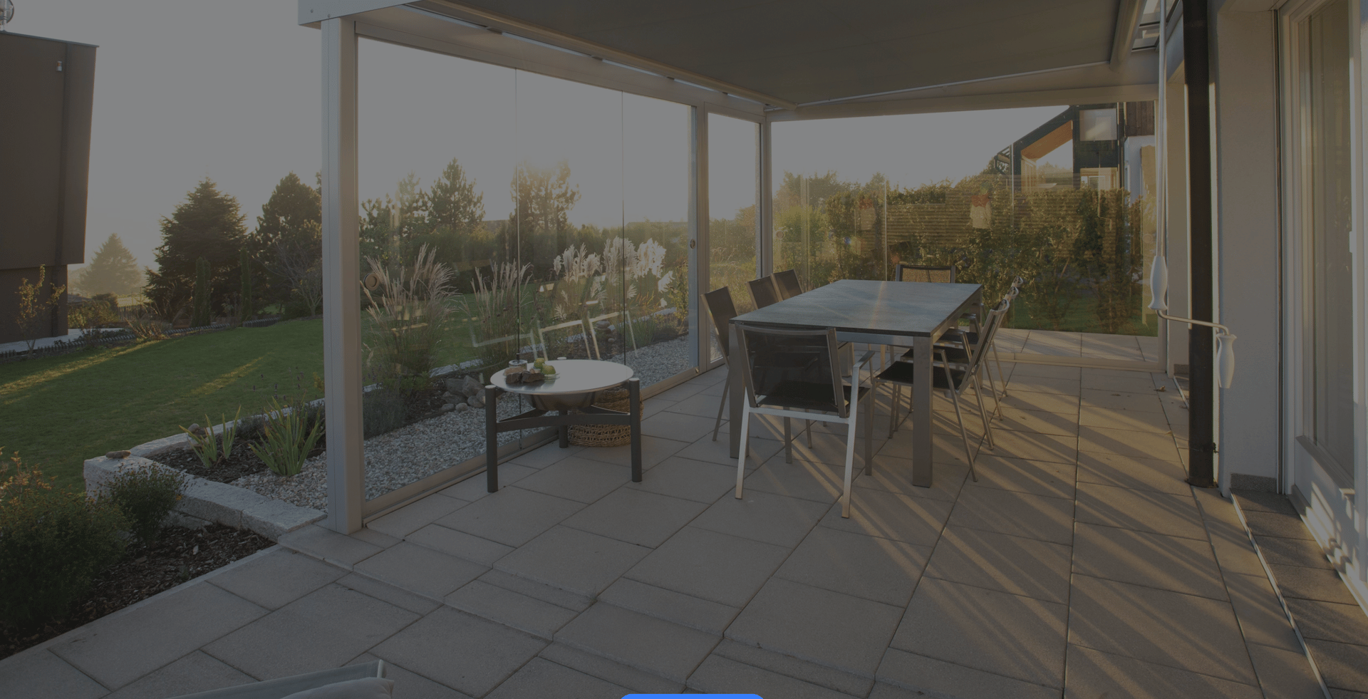 concrete stamped patio with glass table and metal chairs 