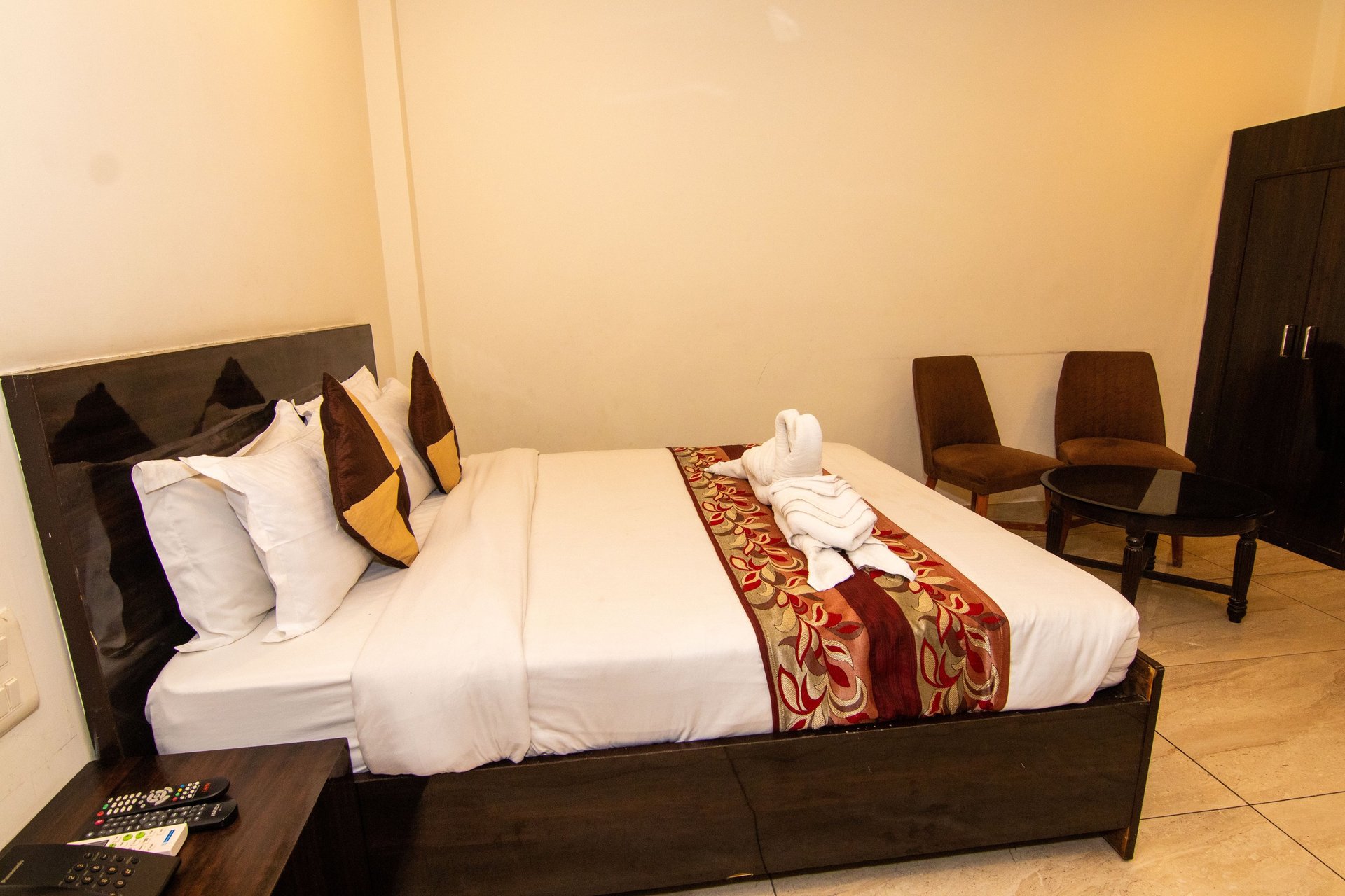 white bed linen with throw pillows