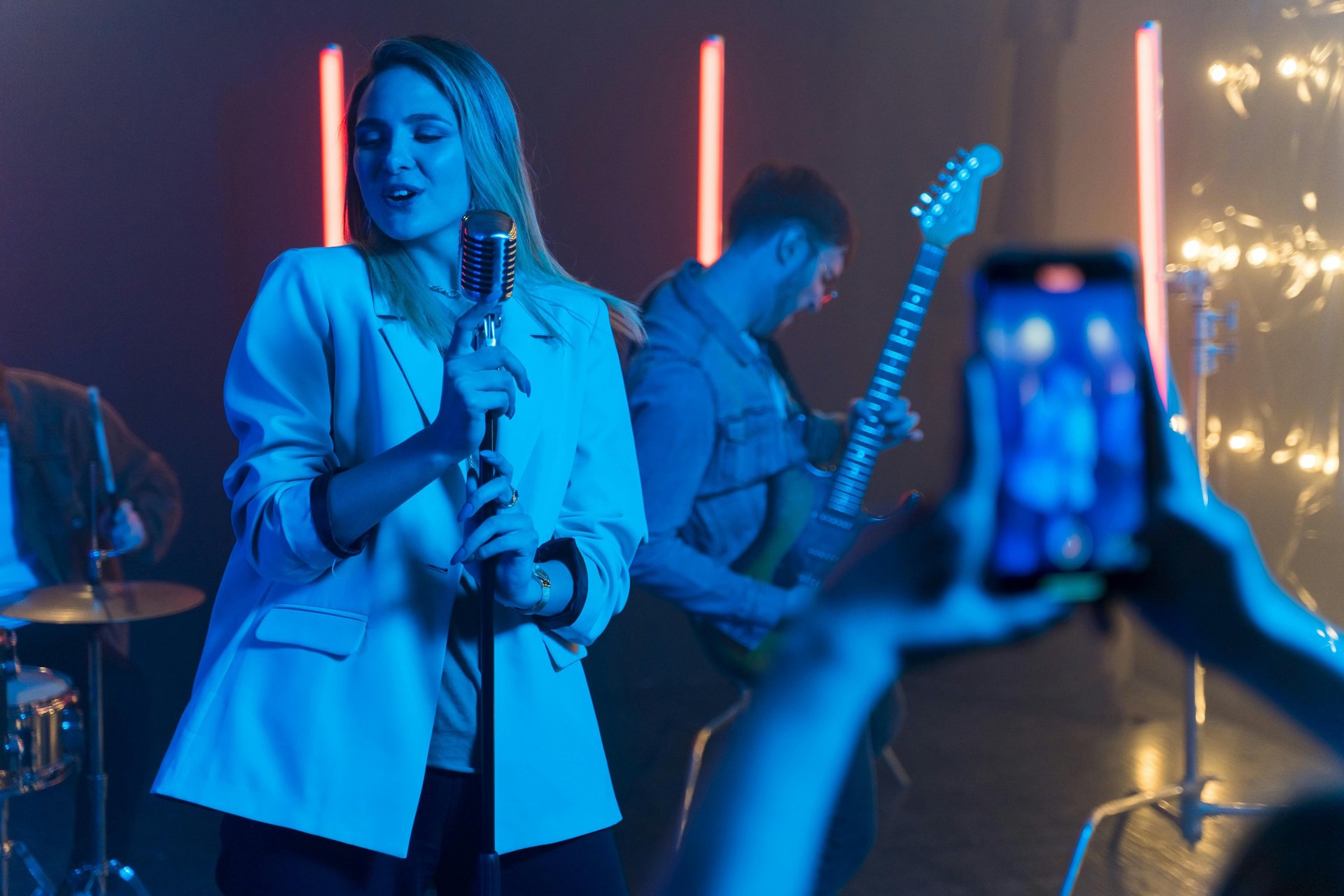 A group of men playing guitars on stage