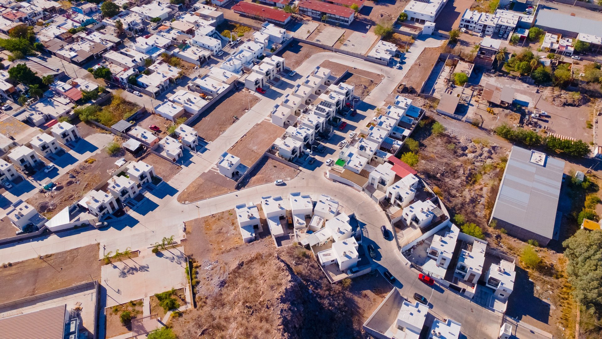 an abstract photo of a curved building with a blue sky in the background