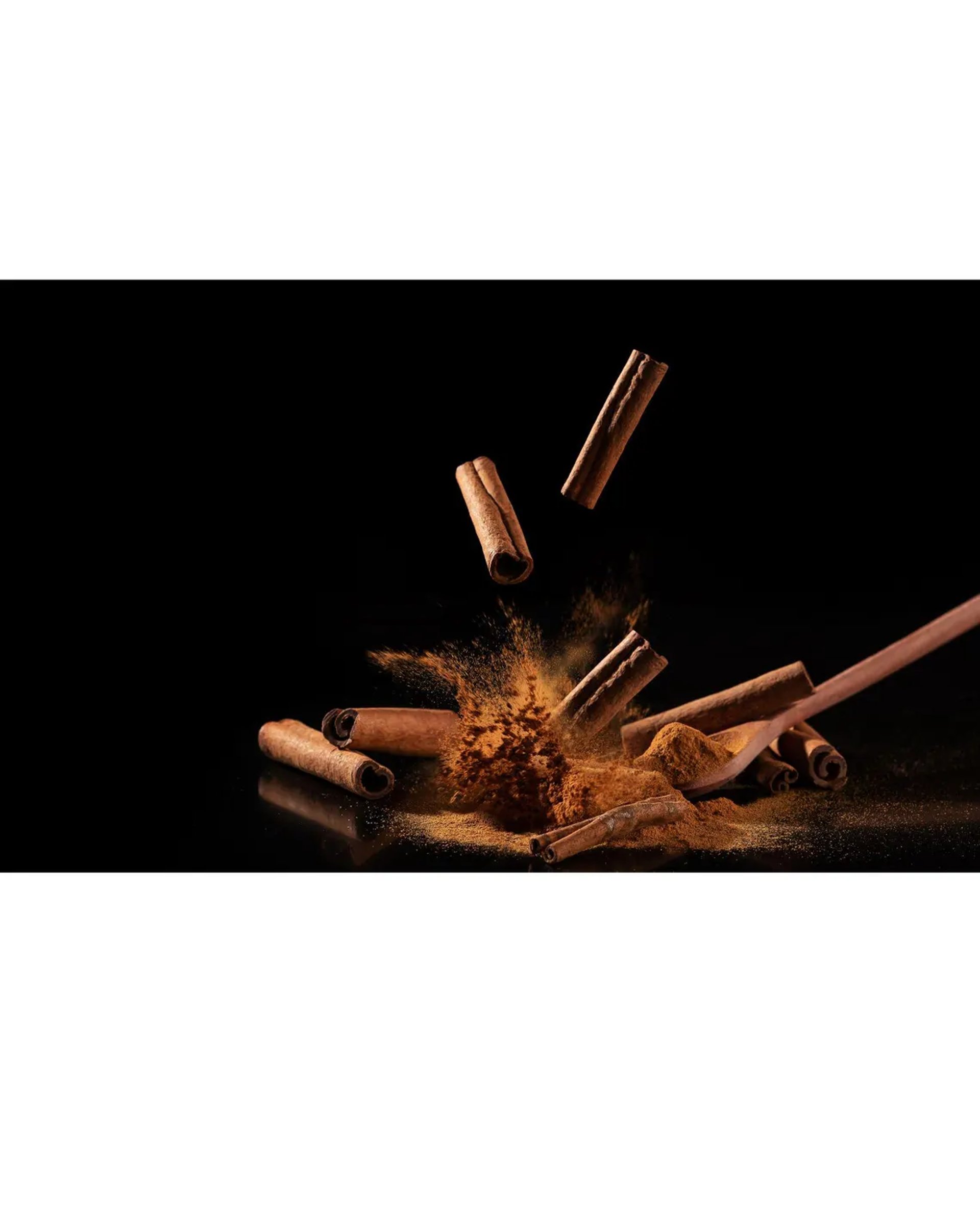 a bowl of nuts and cinnamon sticks on a table